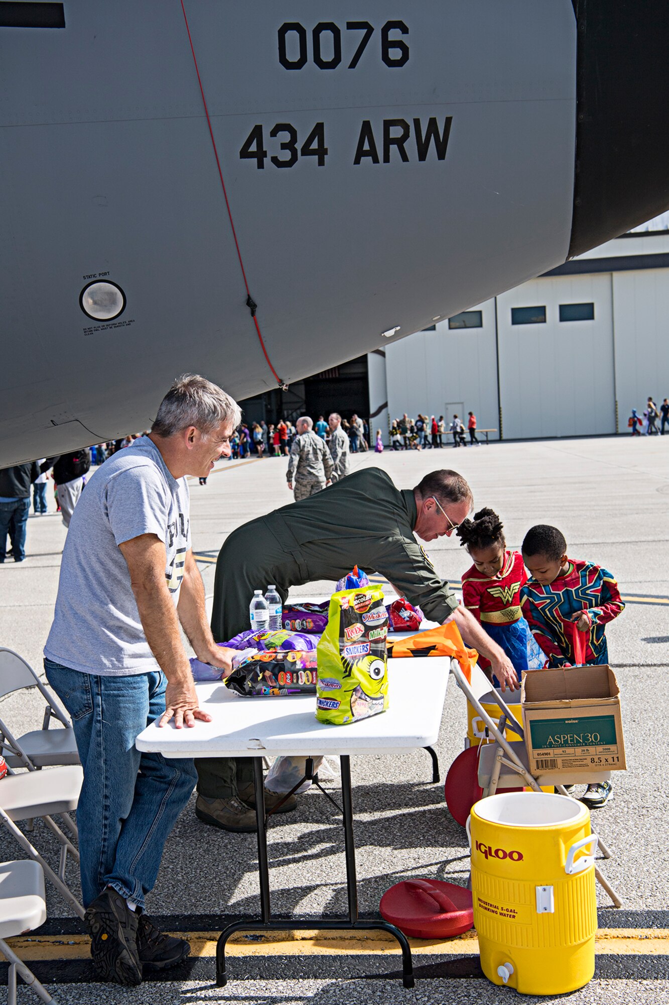 Lt. Col. Doug Perry, 434th Operations Support Squadron, left, and Lt. Col. Joe Austin, 72nd Air Refueling Squadron, help some young super heroes get candy Oct. 6, 2019 during a ‘Tanker Treat’ held during a fall festival at Grissom Air Reserve Base, Indiana. The festival gave unit members and their families an opportunity to focus on resiliency and throttle back after busy year of deployments, exercises, inspections and an airshow. (U.S. Air Force photo/Douglas Hays)
