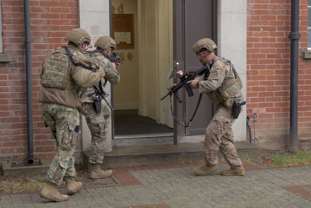 Members of the 100th Security Forces Squadron prepare to raid a building during an active shooter training situation as a part of a readiness exercise at RAF Mildenhall, England, Oct. 4, 2019. Different exercise scenarios were designed to ensure 100th Air Refueling Wing Airmen were fully prepared for potential contingencies in the wing’s area of responsibility. (U.S. Air Force photo by Senior Airman Benjamin Cooper)