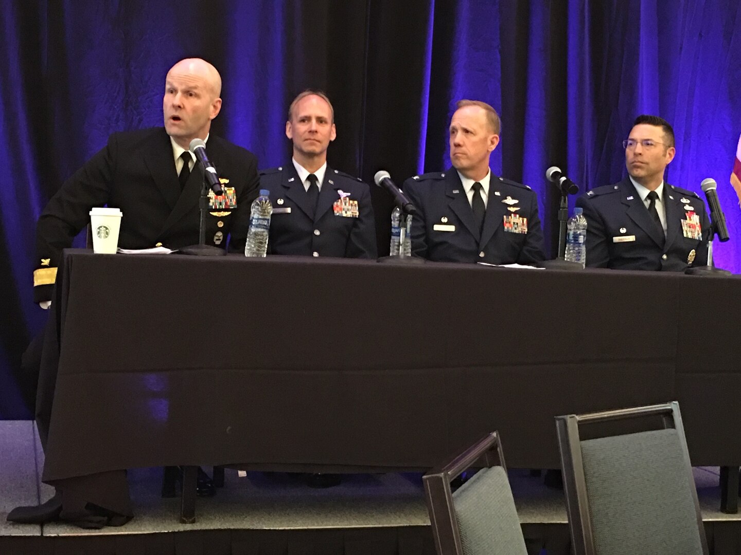 Four men sitting at a conference table.