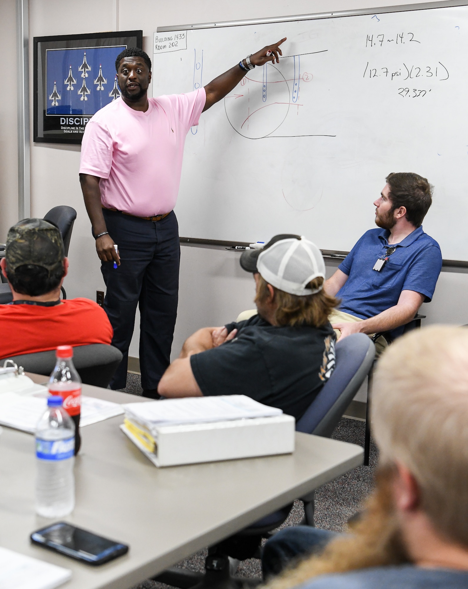 Julius Lockett III, an AEDC senior sysystems engineer, explains the use of a venturi to measure flow to fellow AEDC team members participating in lead operations engineer training Sept. 3 at Arnold Air Force Base. (U.S. Air Force photo by Jill Pickett) (This image was altered by obscuring a badge for security purposes.)