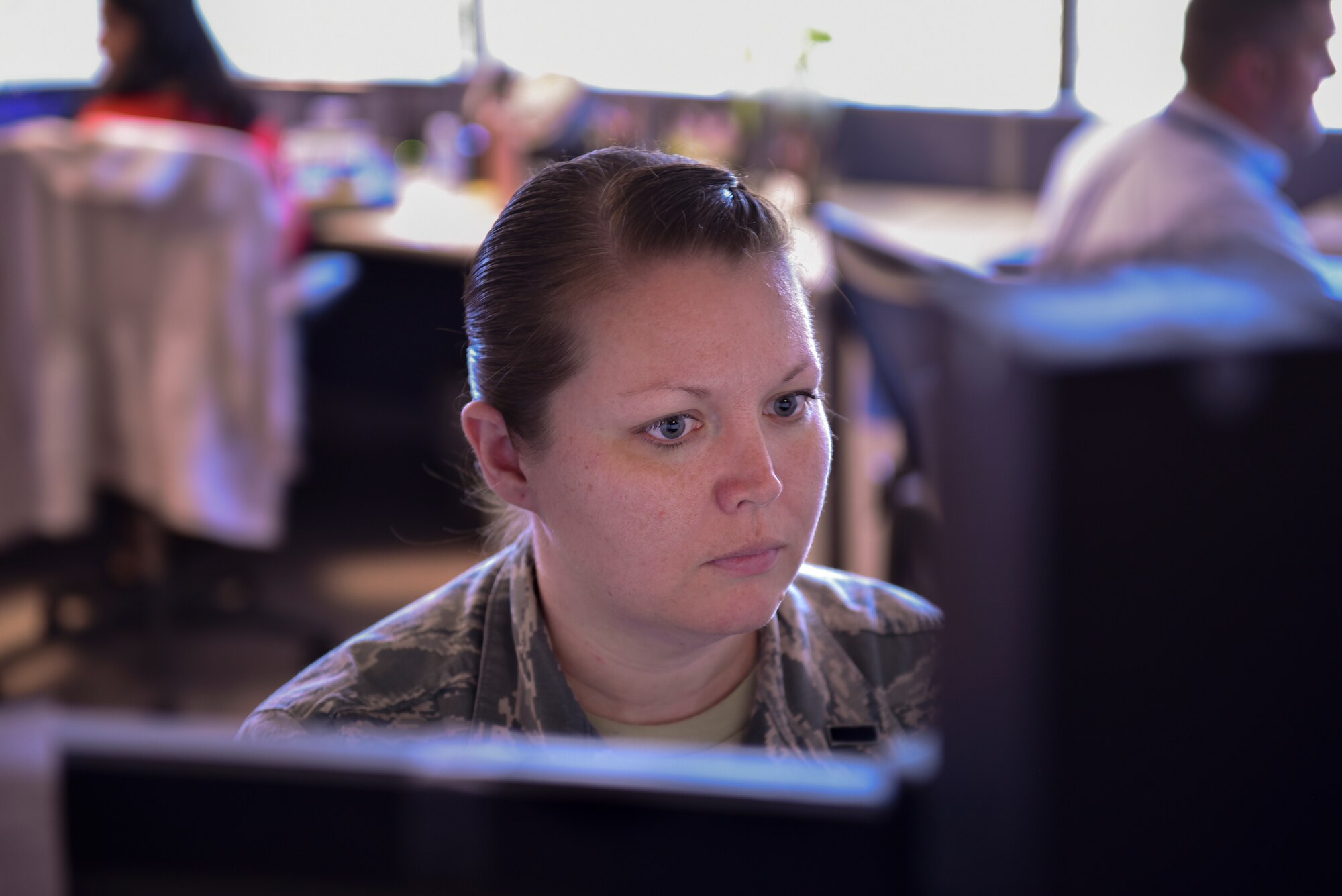 1st Lt. Danielle Sease, 21st Comptroller Squadron flight commander and financial analyst, works at her computer in the finance office Sept. 30, 2019 at Peterson Air Force Base, Colorado. Sept. 30 marked the end of the fiscal year and the end of year closeout for finance. (U.S. Air Force photo by Airman Alexis Christian)