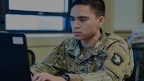 Soldier attending BLC looking at a laptop