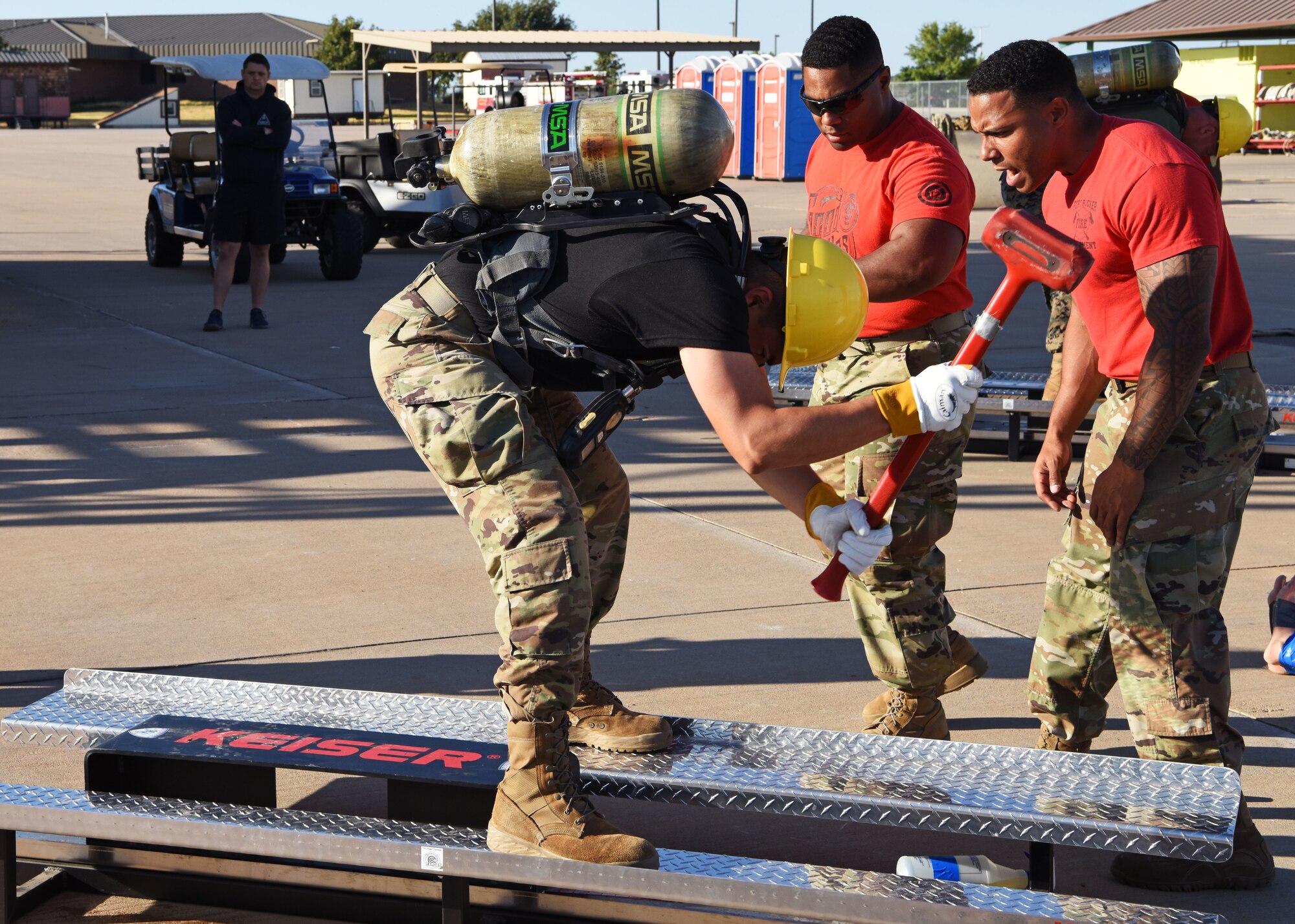 Fire prevention instructors motivate a fellow Soldier as he participates in a team relay involving different firefighter related challenges during Blood, Sweat, and Stairs at the Louis F. Garland Department of Defense Fire Academy on Goodfellow Air Force Base, Texas, Oct. 5, 2019. The relay required teams to work together by completing each challenge at maximum effort. (U.S. Air Force photo by Airman 1st Class Ethan Sherwood/Released)