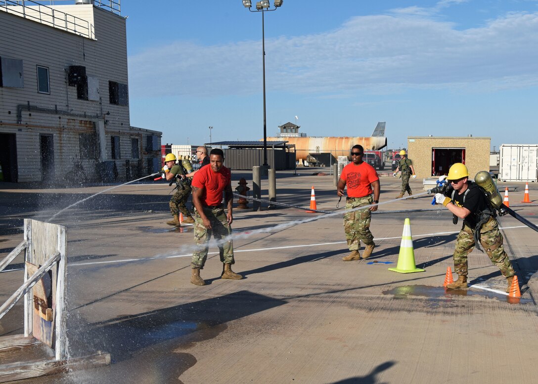 A U.S. Army Soldier fires a hose at a target after dragging it during Blood, Sweat, and Stairs at the Louis F. Garland Department of Defense Fire Academy on Goodfellow Air Force Base, Texas, Oct. 5, 2019. Though the challenges were meant to be fun, they were used to honor those involved in 9/11. (U.S. Air Force photo by Airman 1st Class Ethan Sherwood/Released)