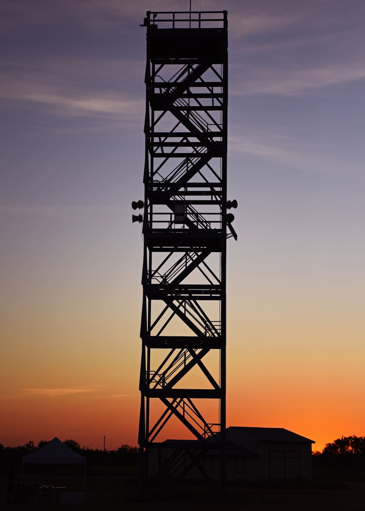 The silhouette of the 90 foot tower stands tall as fire protection professionals prepare to climb its stairs at top speed during Blood, Sweat, and Stairs at the Louis F. Garland Department of Defense Fire Academy on Goodfellow Air Force Base, Texas, Oct. 5, 2019. The stairs gave members of Goodfellow a taste of what first responders endured during 9/11 as they climbed 110 floors. (U.S. Air Force photo by Airman 1st Class Ethan Sherwood/Released)