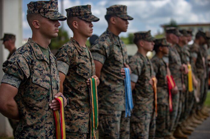 U.S. Marines with 12th Marine Regiment, 3rd Marine Division, participates in the 12th Marine Regiment 92nd Anniversary Battle Colors Rededication Ceremony on Camp Hansen, Okinawa, Japan, Oct. 4, 2019. The ceremony is an opportunity for Marines to remember warriors past and to recognize contributions of service members and families to current operations.