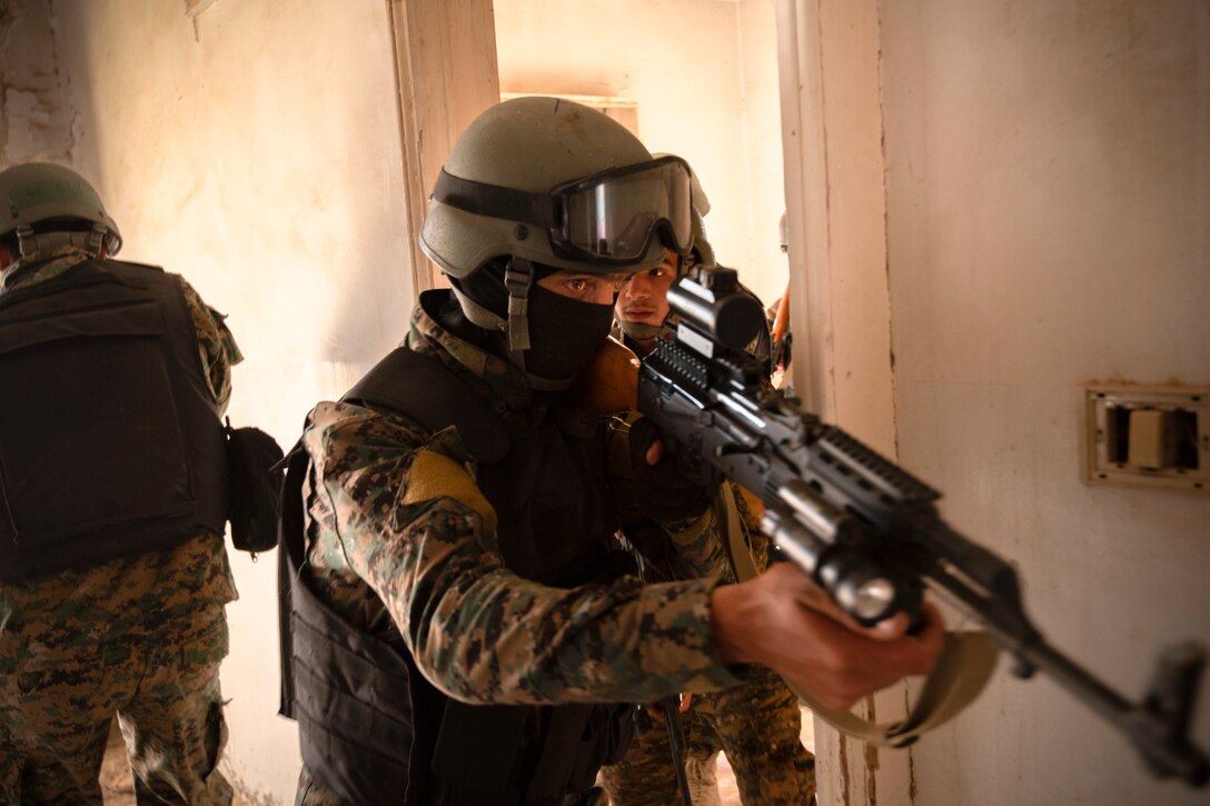 Soldier enters room with rifle.