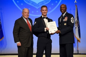 Staff Sgt. Christopher Stuebbe, 628th Logistics Readiness Squadron forward area refueling point team chief, accepts a 12 Outstanding Airmen of the Year plaque from Chief Master Sgt. of the Air Force Kaleth O. Wright Sept. 16, 2019, at Fort Washington, Md.