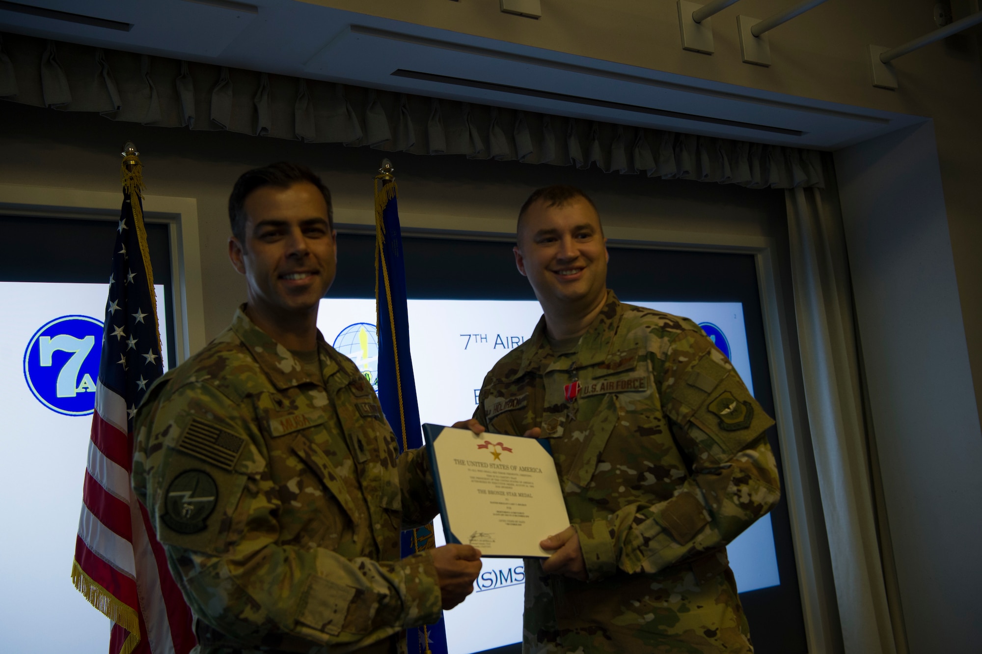 Lt. Col. Jamil Musa, left, 7th Airlift Squadron commander, presents Master Sgt. Casey Holihan, 7th AS superintendent, with a Bronze Star Medal during a ceremony at Joint Base Lewis-McChord, Wash., Oct. 7, 2019. Holihan received the medal for his actions while deployed to Forward Operating Base Oqab, Kabul, Afghanistan.