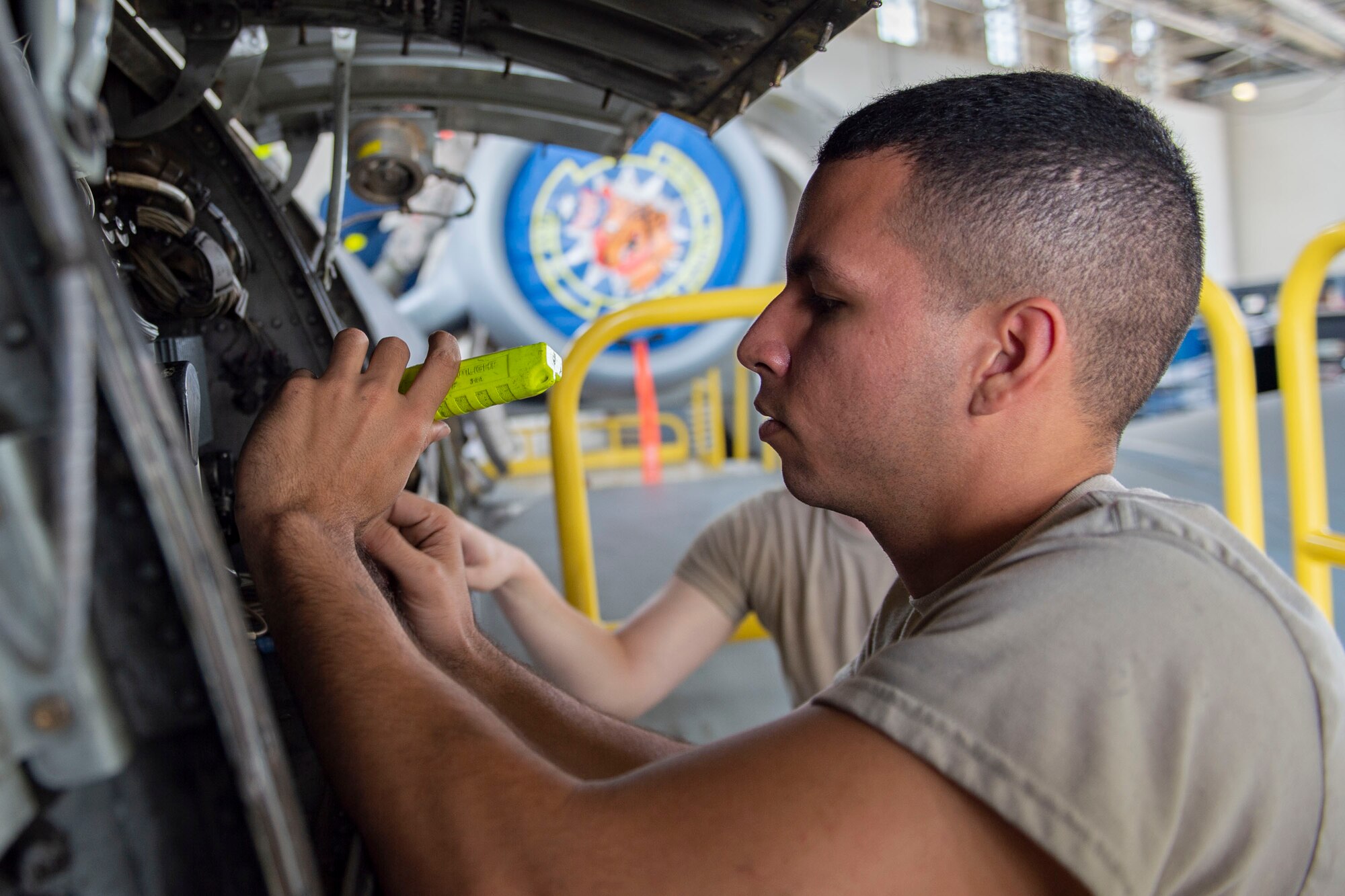 Airman 1st Class Ewing Maldonado, 23d Maintenance Squadron (MXS) electrical and environmental journeyman, examines wires during an A-10C Thunderbolt II phase inspection Oct. 8, 2019, at Moody Air Force Base, Ga. The 23d MXS maintainers depanel the aircraft to reach the internal workings and perform in depth examinations on A-10s after every 500 flight hours. These maintainers work day and night to ensure the aircraft are safe and reliable combat assets. (U.S. Air Force photo by Airman Azaria E. Foster)