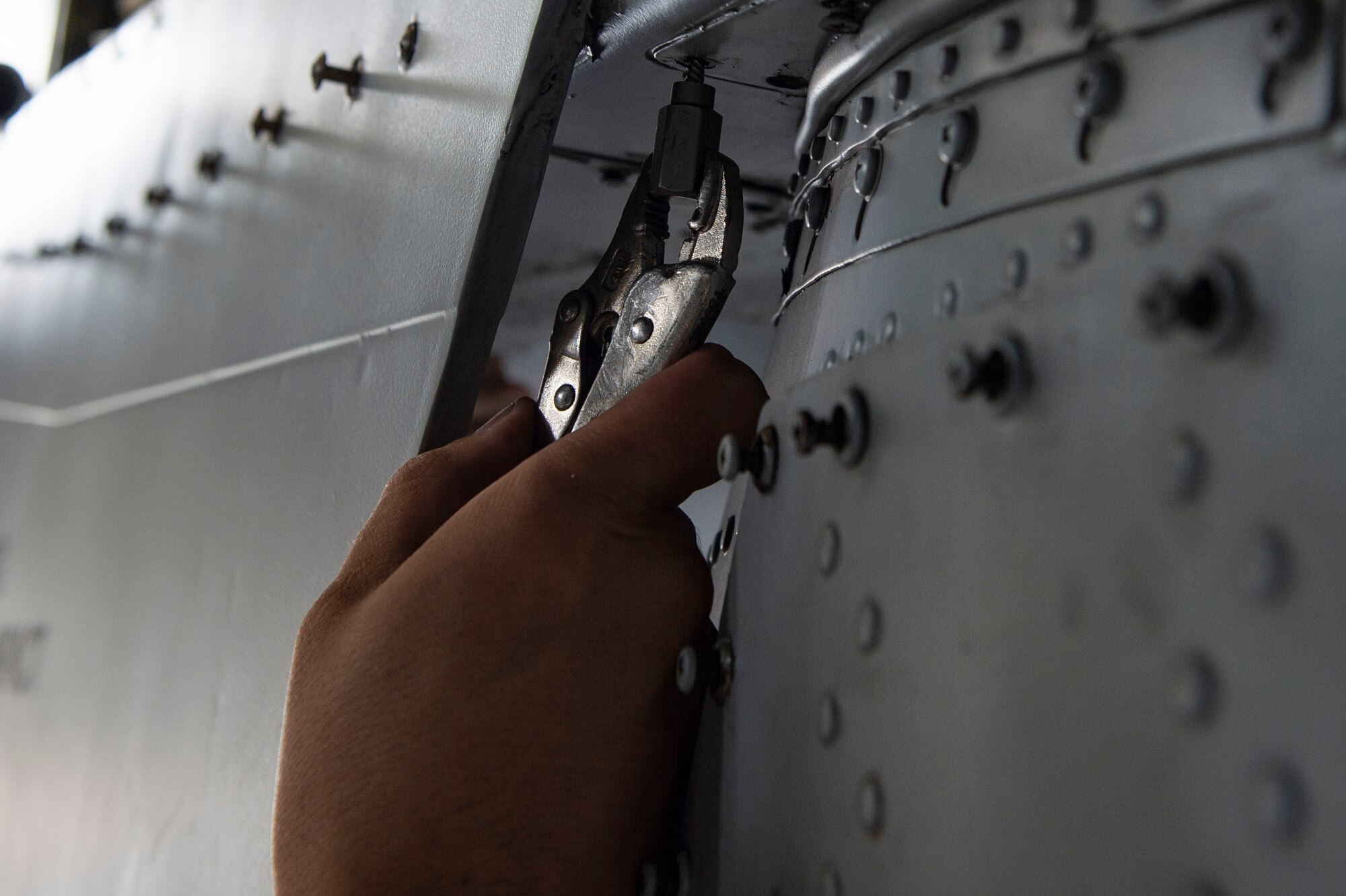 An Airman assigned to the 23d Maintenance Squadron (MXS) removes a screw during an A-10C Thunderbolt II phase inspection Oct. 8, 2019, at Moody Air Force Base, Ga. The 23d MXS maintainers depanel the aircraft to reach the internal workings and perform in depth examinations on A-10s after every 500 flight hours. These maintainers work day and night to ensure the aircraft are safe and reliable combat assets. (U.S. Air Force photo by Airman Azaria E. Foster)