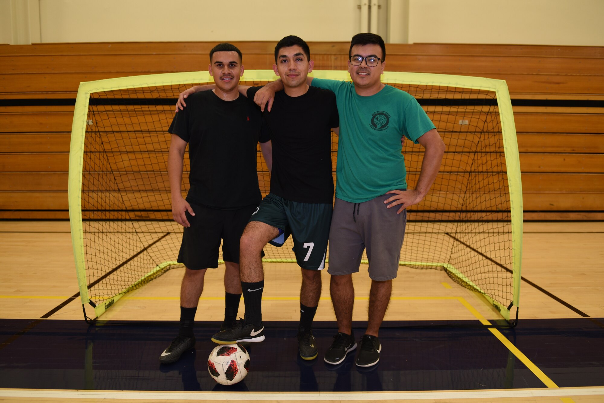 U.S. Air Force Senior Airman Emanuel Guzman, left, 60th Logistics Readiness Squadron field training and support journeyman, Staff Sgt. Edwin Suarez, middle, 921st Contingency Response Squadron air transportation craftsman and Airman 1st Class Brian Ortega, right, 60th Logistics Readiness Squadron materiel management journeyman, pose together after their Club Hub soccer match Oct. 4, 2019, at Travis Air Force Base, California. Club Hub is a program that allows Airmen to organize groups or join other Airmen in activities that interest them. (U.S. Air Force photo by Airman 1st Class Cameron Otte)