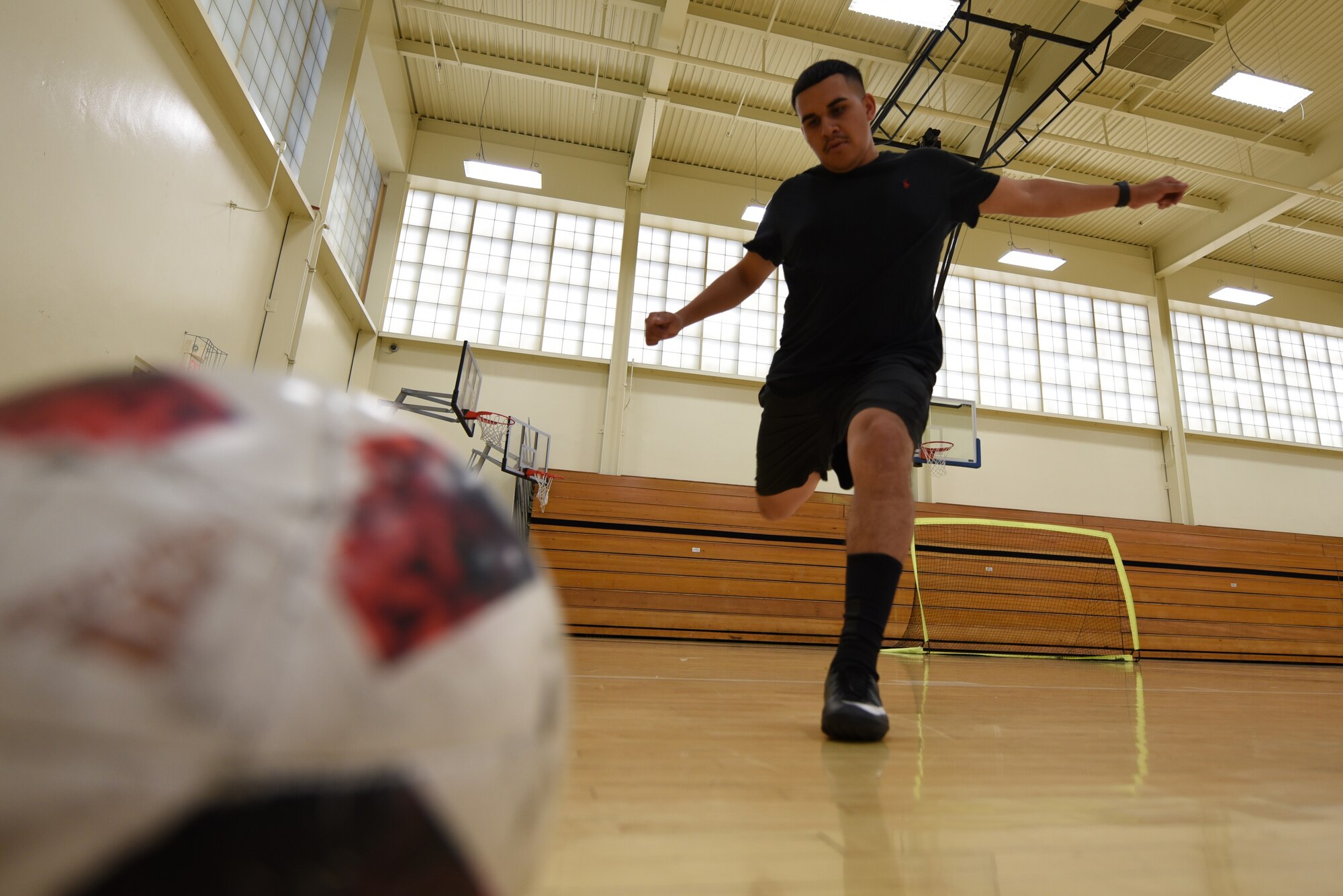 U.S. Air Force Staff Sgt. Edwin Suarez, 921st Contingency Response Squadron air transportation craftsman, goes for a kick during a Club Hub soccer match Oct. 4, 2019, at Travis Air Force Base, California. Club Hub is a program that allows Airmen to organize groups or join other Airmen in activities that interest them. (U.S. Air Force photo by Airman 1st Class Cameron Otte)