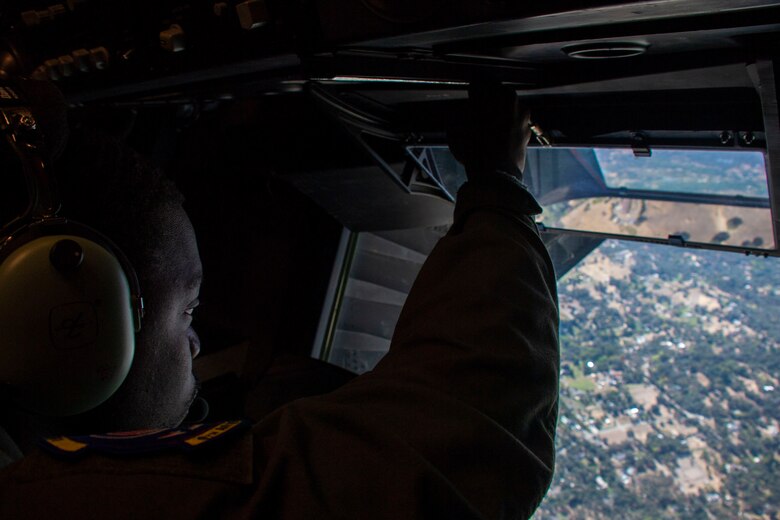 U.S. Air Force Staff Sgt. Cornelius Frazier, 9th Air Refueling Squadron boom operator, opens the hatch for the boom on a KC-10 Extender Oct. 6, 2019.