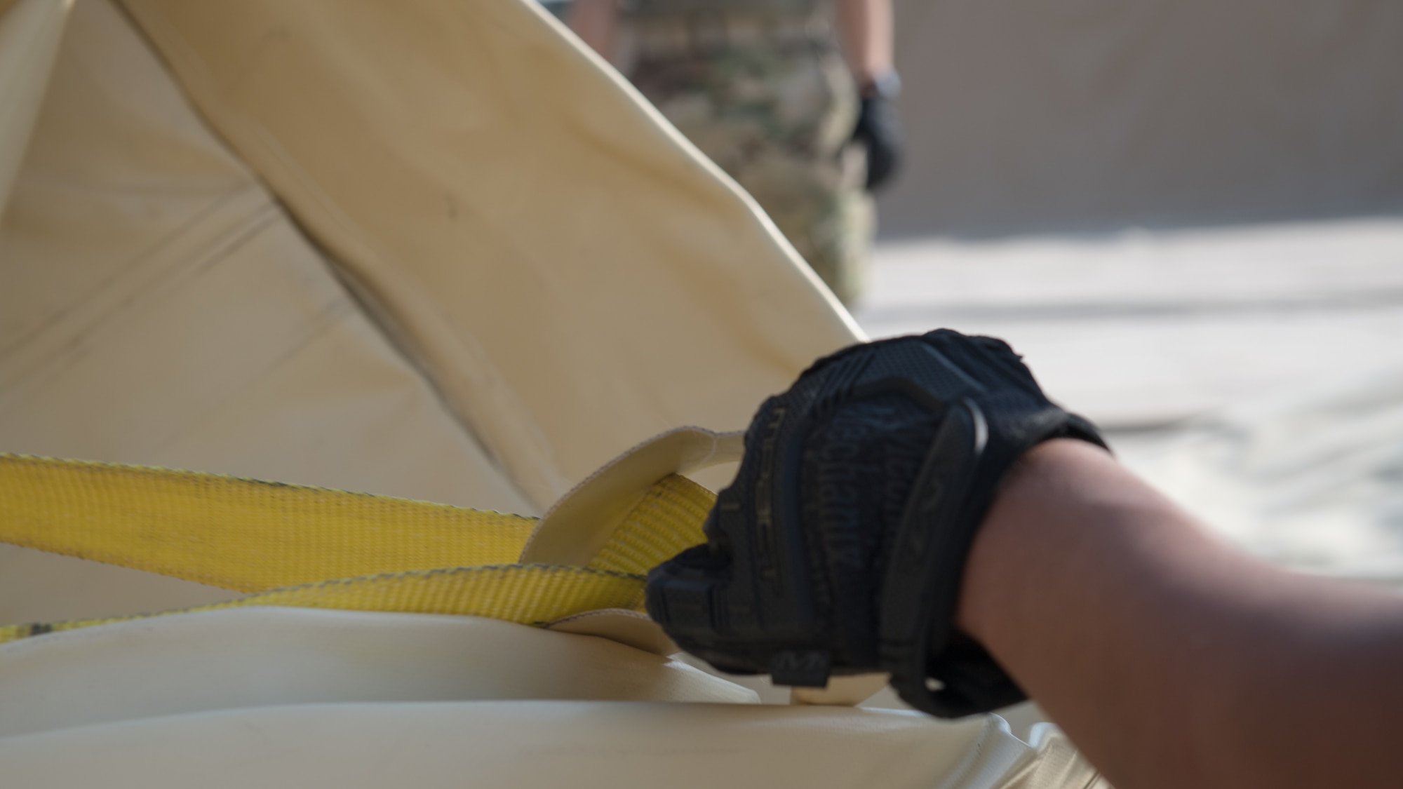 A U.S. Air Force Airman with the 386th Expeditionary Logistics Readiness Squadron fuels management flight loosens a strap on a new fuel bladder at Ali Al Salem Air Base, Kuwait, Oct. 7, 2019. Fuel bladders are replaced every three-to-four years after they become unserviceable. (U.S. Air Force photo by Tech. Sgt. Daniel Martinez)
