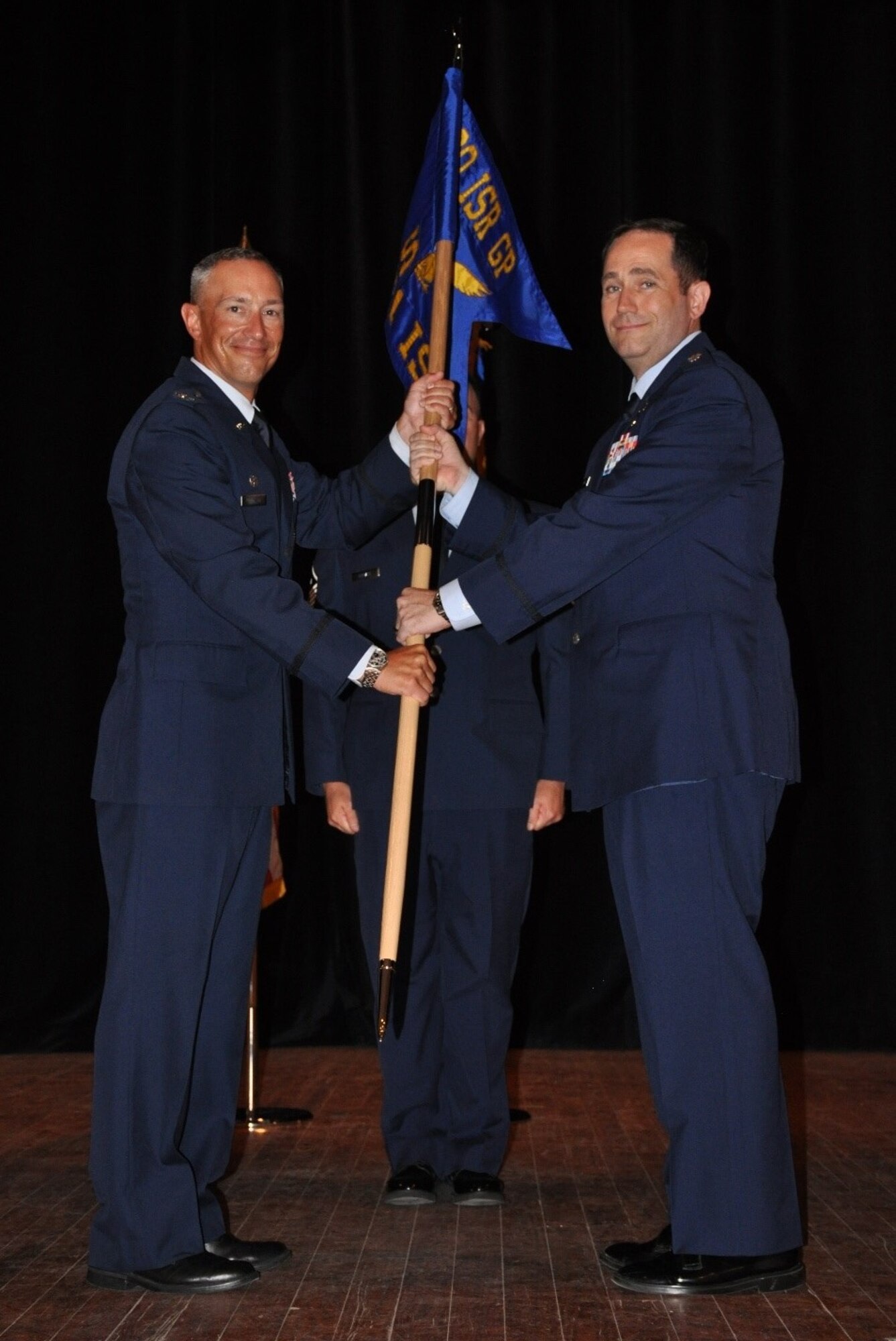 U.S. Air Force Col. Abraham Jackson, 480th Intelligence, Surveillance and Reconnaissance Group commander, presents the guidon to Lt. Col. James Fagan, 451st Intelligence Squadron, during an assumption of command ceremony in Signal Theater at Fort Gordon, Georgia, July 11, 2019. The 451st IS was stood up in order to conduct and execute Air Force and national analysis and reporting capabilities using tactical and national resources to provide intelligence products for U.S. Central Command, U.S. European Command and U.S. Southern Command operations, plans and forces, and the execution of Air Force national and tactical integration operations. (Courtesy photo)