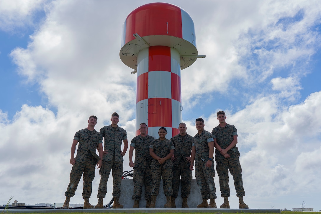 Air traffic control maintenance Marines with Headquarters and Headquarters Squadron pose in front of the new AN/FPN-68 Precision Approach Radar’s antenna Sept. 30, 2019 on Marine Corps Air Station Futenma, Okinawa, Japan. MCAS Futenma is the first Marine Corps Air Station to receive the new radar system. (U.S. Marine Corps photo by Lance Cpl. Brennan J. Beauton)