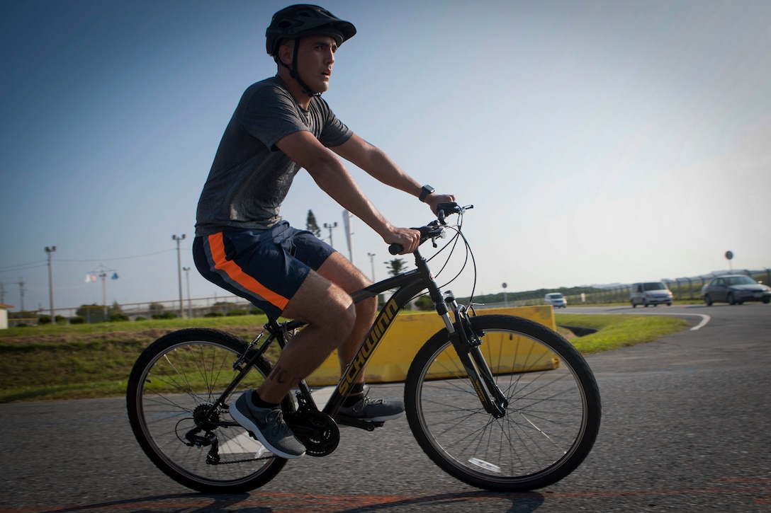 U.S. Air Force Tech Sgt. Ryan Edison, military police officer with 18th Wing Security Forces, competes in the biking portion of the 2019 Futenma Triathlon on Marine Corps Air Station Futenma, Okinawa, Japan, Oct. 6, 2019. The triathlon is held in order to strengthen the relationship between U.S. service members and residents of Okinawa through athletic events. (U.S. Marine Corps photo by Cpl. Samuel Brusseau)