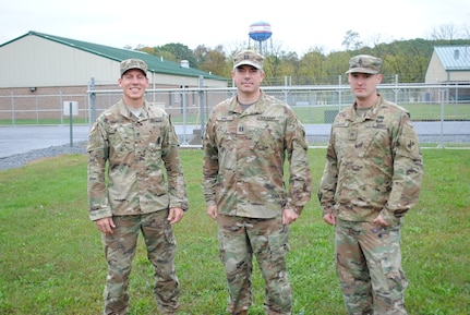 From left to right, Staff Sgt. Michael Bradley, Capt. John King and Staff Sgt. Jonathan Harper pose for a photo outside a warfighter exercise at Fort Indiantown Gap, Pennsylvania. The trio rushed to the aid of fellow citizens after a three vehicle crash on Interstate 81, Sept. 30.