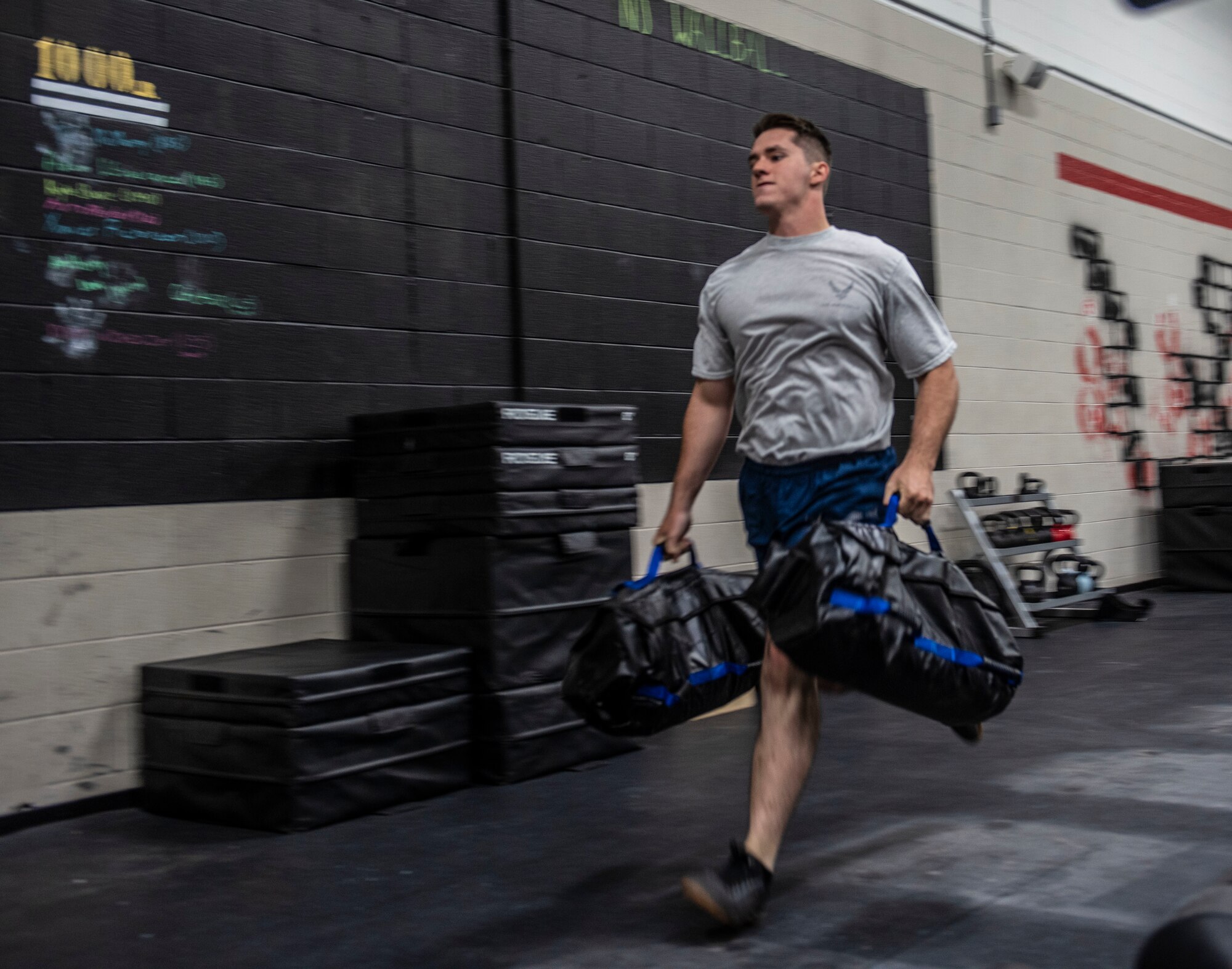 U.S. Air Force Senior Airman Zachary Stringer, 20th Civil Engineer Squadron, Explosive Ordnance Disposal (EOD) flight technician, runs with sandbags during a Tier 2 physical fitness practice test at Shaw Air Force Base, South Carolina, Oct. 4, 2019.