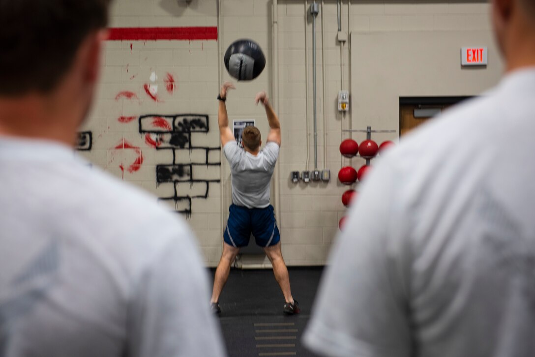 U.S. Air Force Senior Master Sgt. Andrew Filcher, 20th Civil Engineer Squadron, Explosive Ordnance Disposal (EOD) flight superintendent, throws a 20-pound medicine ball in the air at Shaw Air Force Base, South Carolina, Oct. 4, 2019.