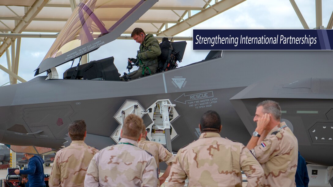 Group of Netherlands' military leaders look on as an F-35 pilot gets out of the cockpit.