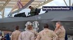 Group of Netherlands' military leaders look on as an F-35 pilot gets out of the cockpit.