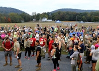 Participants gather at the start of the eighth annual March for the Fallen event Sept. 28, 2019 on Strickler Field at Fort Indantown Gap, Pa. Many participants took time to observe the Wall of Remembrance, which depicts 47 fallen Pennsylvania service members. (U.S. Army National Guard photo by Sgt. 1st Class HollyAnn Nicom)