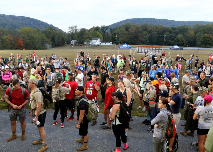 Participants gather at the start of the eighth annual March for the Fallen event Sept. 28, 2019 on Strickler Field at Fort Indantown Gap, Pa. Many participants took time to observe the Wall of Remembrance, which depicts 47 fallen Pennsylvania service members. (U.S. Army National Guard photo by Sgt. 1st Class HollyAnn Nicom)