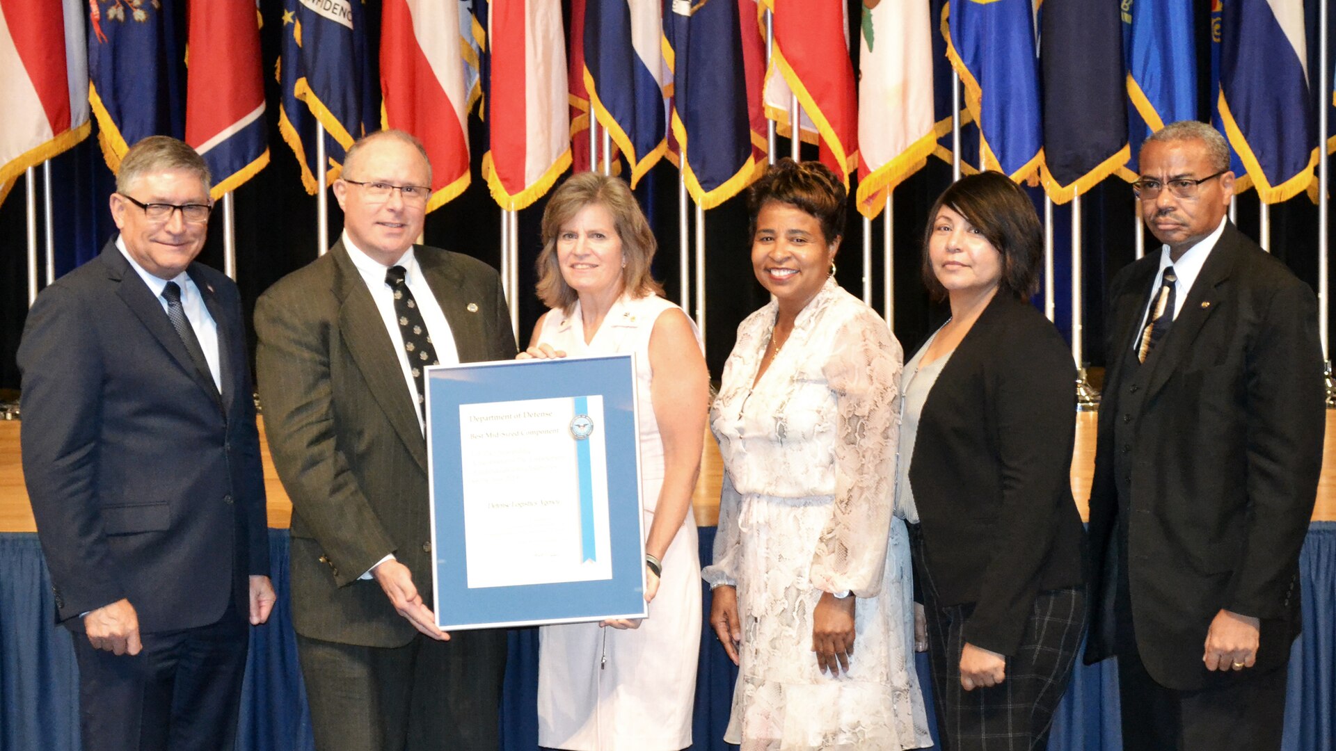 James Stewart, assistant secretary of defense for manpower and reserve affairs (left), poses for a photo with members of the DLA EEO team during the 39th Annual Secretary of Defense Disability Awards ceremony at the Pentagon Oct. 3. Left to right are: Stewart; Eric Spanbauer, DLA Workforce Recruitment Program manager; DLA Chief of Staff Kristin French; DLA EEO Director Janice Samuel; DLA Disability Program Manager Nancy Rivera; and Russell Lowe, DLA’s staff director