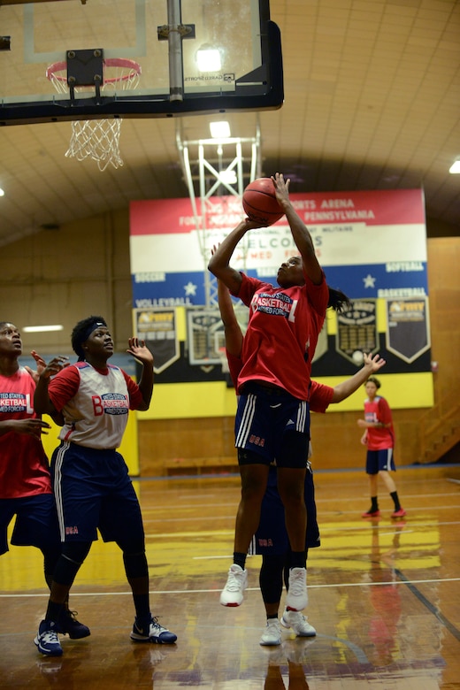 A woman shoots a basketball.