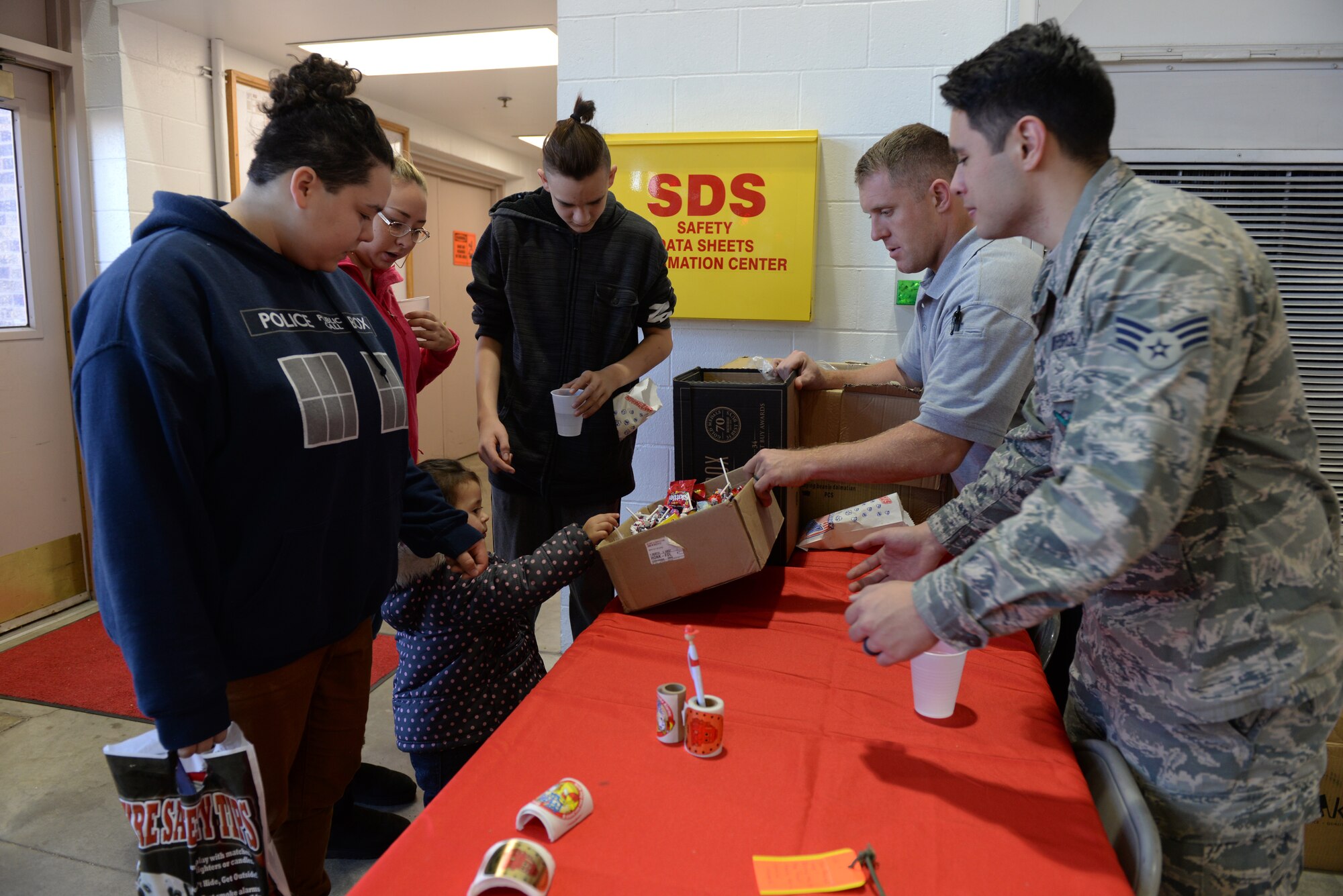 Airmen give out candy to children during the Fire Prevention Week Open House event at the 28th Civil Engineer Squadron Fire Department at Ellsworth Air Force Base, S.D., Oct. 5, 2019.  Fire Prevention Week is observed each year during the week of Oct. 9, which commemorates the “Great Chicago Fire” from 1871, and is a time in which fire departments worldwide remind communities to take the appropriate measures and precautions to prevent fires. (U.S. Air Force photo by Airman Quentin K. Marx)