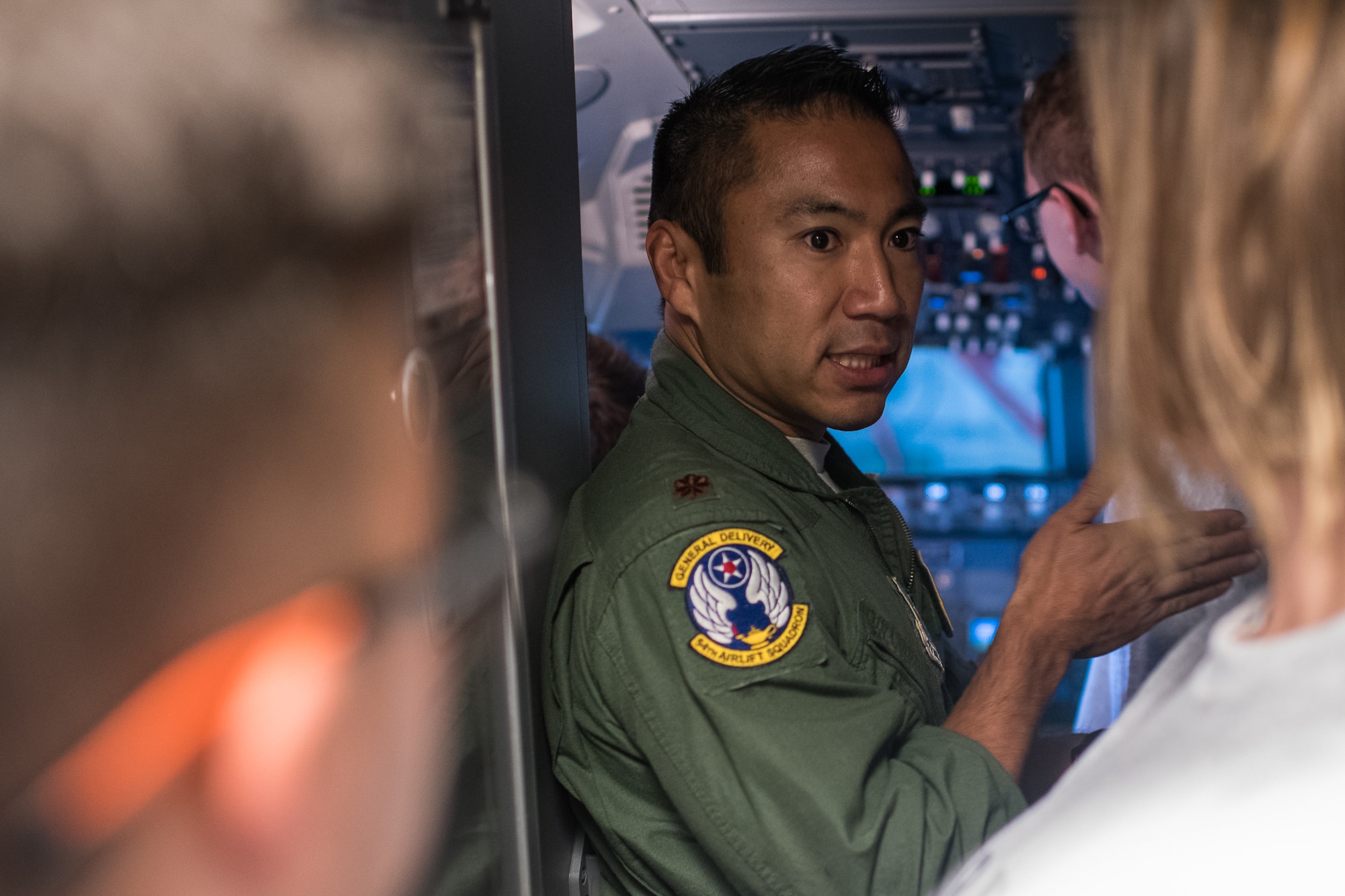 Maj. Andrew Floro, 54th Airlift Squadron pilot, answers questions about the flight deck and aircraft controls to area high school students during the JROTC Day event at at Scott Air Force Base, Illinois, Oct. 8, 2019. More than 400 high school students from 11 schools across Missouri and Illinois learned about various careers in the Air Force. (U.S. Air Force photo by Christopher Parr)