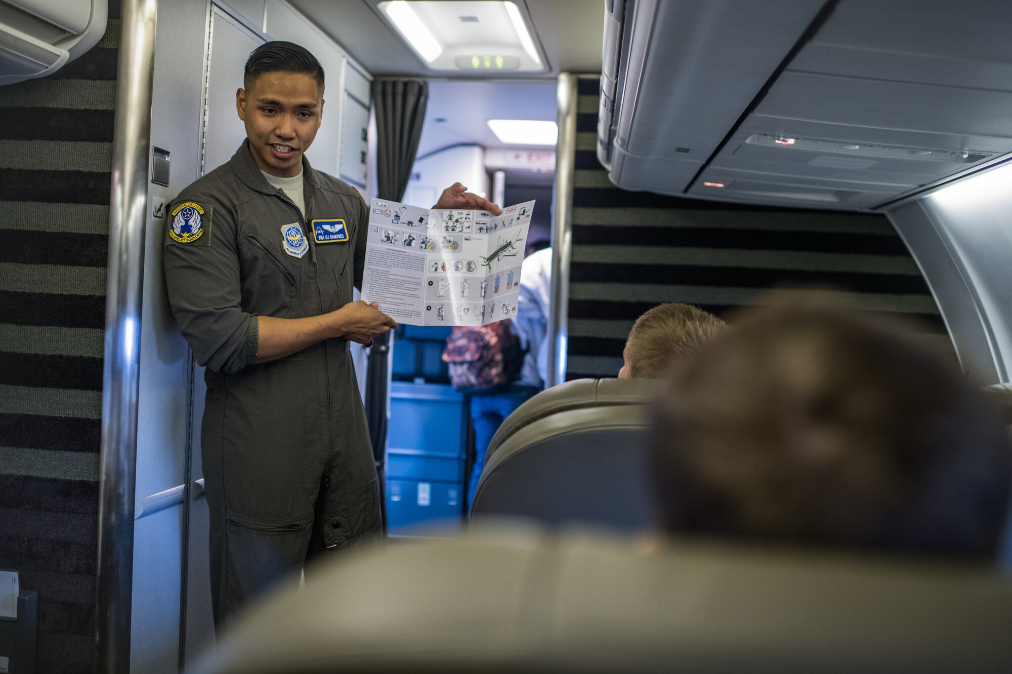 Senior Airman DJ Ramones, 54th Airlift Squadron executive flight attendant, gives a briefing to area high school students about duties of an executive flight attendant and provides a tour of a C-40C during the JROTC Day event at at Scott Air Force Base, Illinois, Oct. 8, 2019. More than 400 high school students from 11 schools across Missouri and Illinois learned about various careers in the Air Force. (U.S. Air Force photo by Christopher Parr)