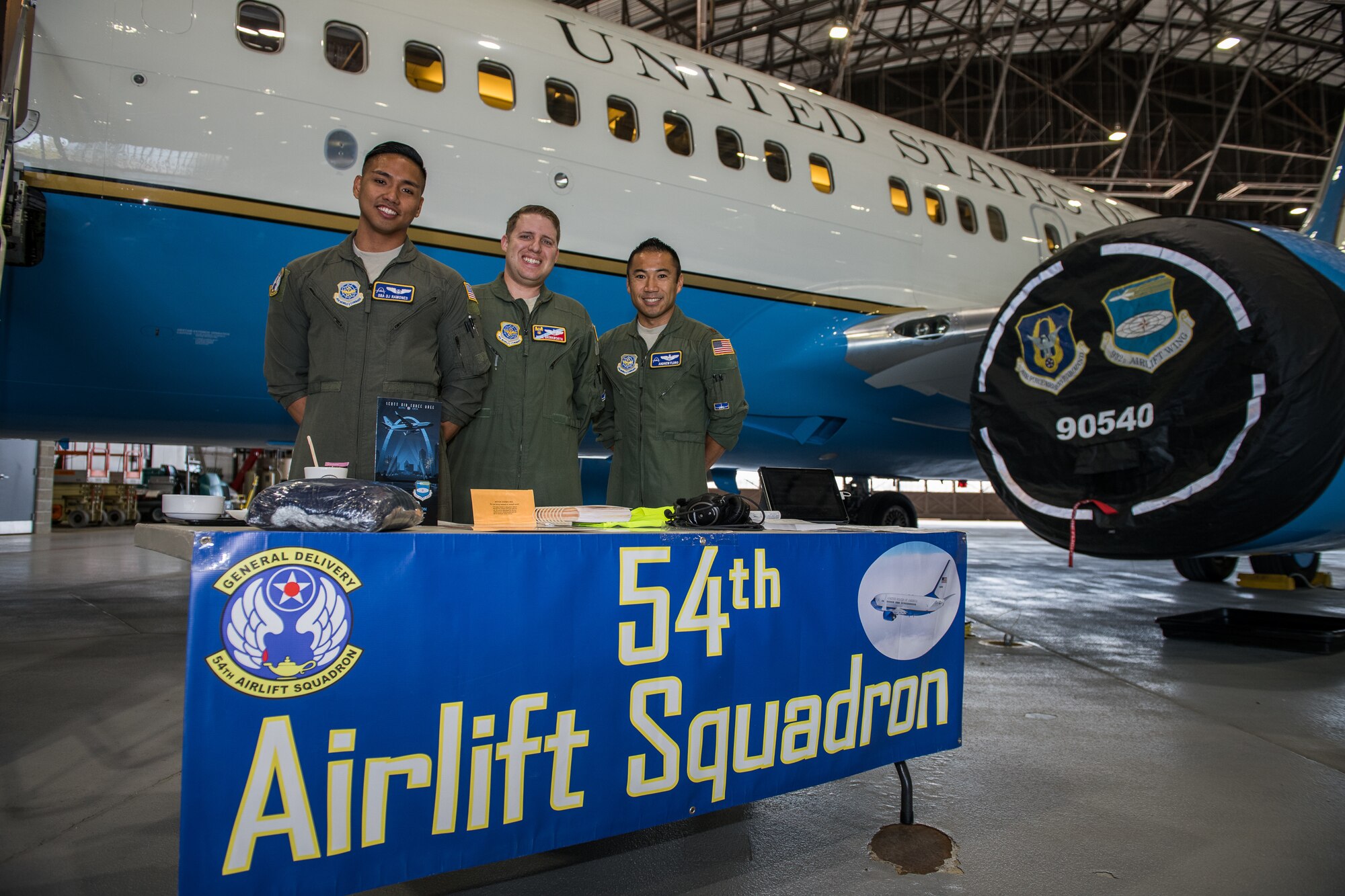 Crew from the 54th Airlift Squadron, pilots  Maj. Andrew Floro, right, Maj. Neal Brinkworth, center, and executive flight attendant Senior Airman DJ Ramones, take a photo moment before giving tours of the 932nd Airlift Wing C-40 aircraft and sharing their Air Force careers with nearly 400 visiting JROTC high students from Missouri and Illinois, Oct. 8, 2019, Scott Air Force Base, Illinois. (U.S. Air Force photo by Christopher Parr)
