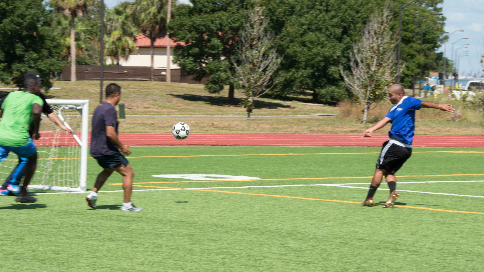 U.S. Air Force Tech. Sgt. Johann Bermudez (right), the 6th Health Care Operations Squadron family health NCO in charge, kicks a ball toward the goal, Oct. 4, 2019, at MacDill Air Force Base, Fla. Over 50 participants played in the Hispanic Heritage Soccer Tournament, and awards were given to first, second, and third place teams. (U.S. Air Force photo by Airman 1st Class Shannon Bowman)