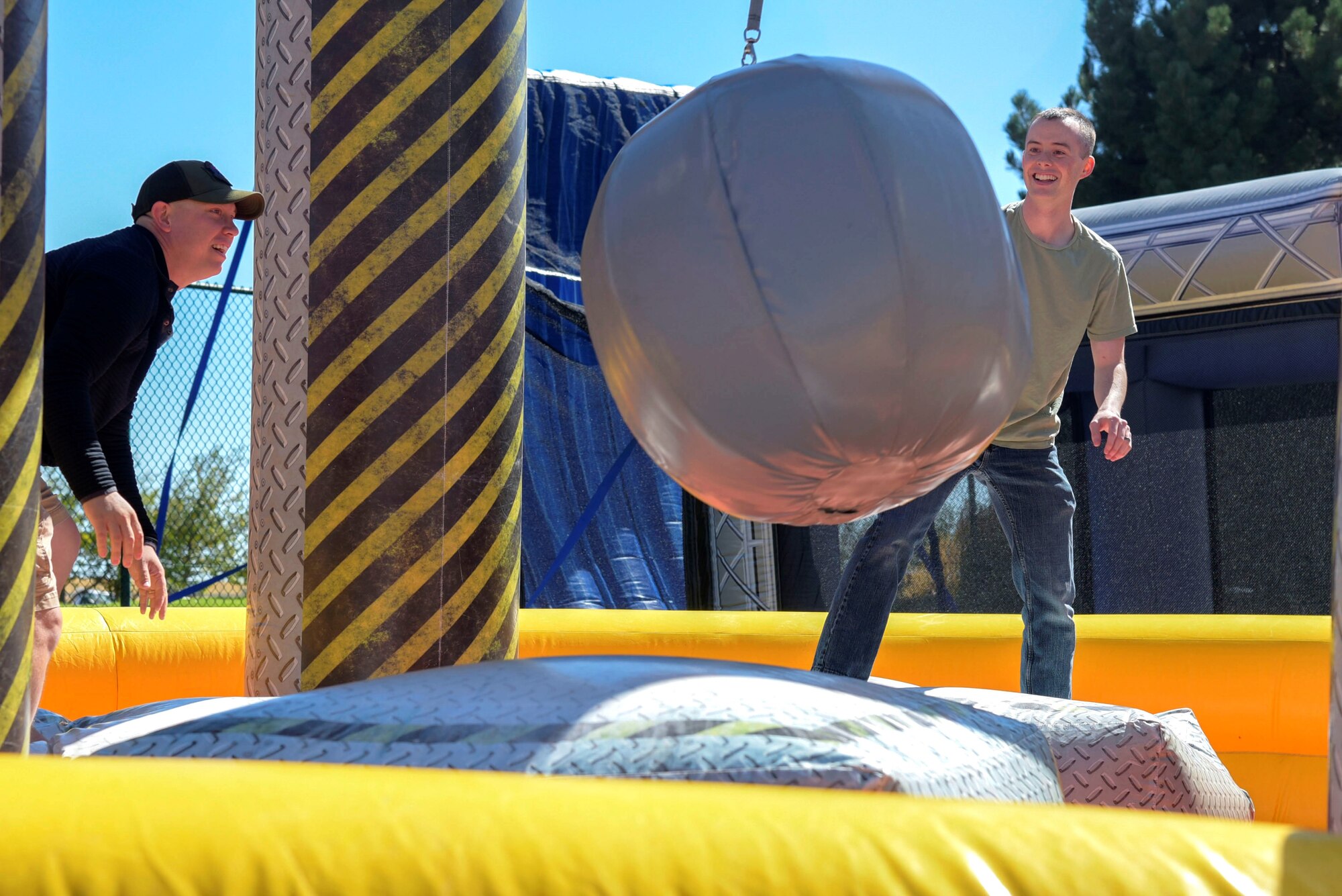 Master Sgt. Preston Brown, 460th Cyber Squadron operations support flight chief (left), 2nd Lieutenant Timothy Blondin, 460th Cyber Squadron operations flight commander (right), participate in a wrecking ball competition at the Team Buckley Connects Day on Sept. 27, 2019, Buckley Air Force Base, Colo.