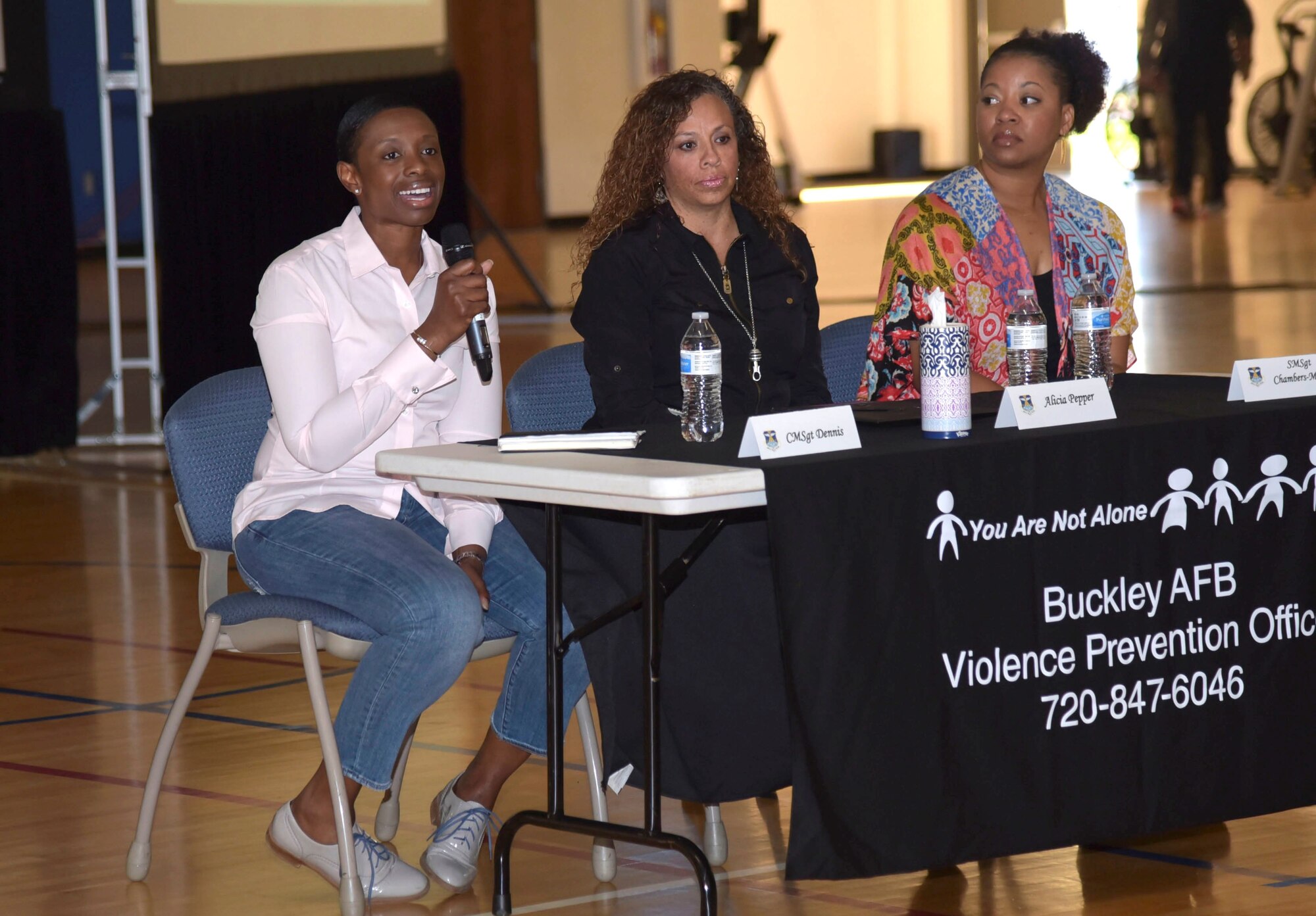 From left to right, Chief Master Sgt. Tamar Dennis, 460th Space Wing command chief, Alicia Pepper, 460th SW commander’s spouse, Senior Master Sgt. Pourschia Chambers-Motley, Air Reserve Personnel Center, classification and individual reserve training manager, speak at the Team Buckley Connects Day on Sept. 27, 2019 at Buckley Air Force Base, Colo.