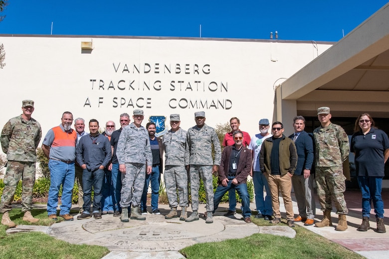 Leaders with the 50th Space Wing stop for a photo with the 21st Space Operations Squadron Vandenberg Tracking Station team on top of the historical cement plaques of all the previous site commanders and leads, at Vandenberg Air Force Base, California, Oct. 2, 2019. Vandenberg Tracking Station is responsible for providing support for launches and coordination on-orbit support for space assets.  (U.S. Air Force photo by Maj. Ryan Harris)