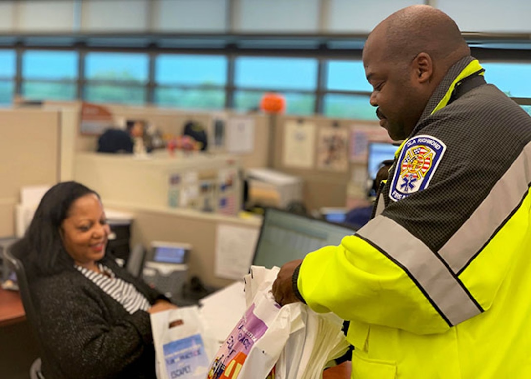 Fire prevention inspector hands out materials to employees