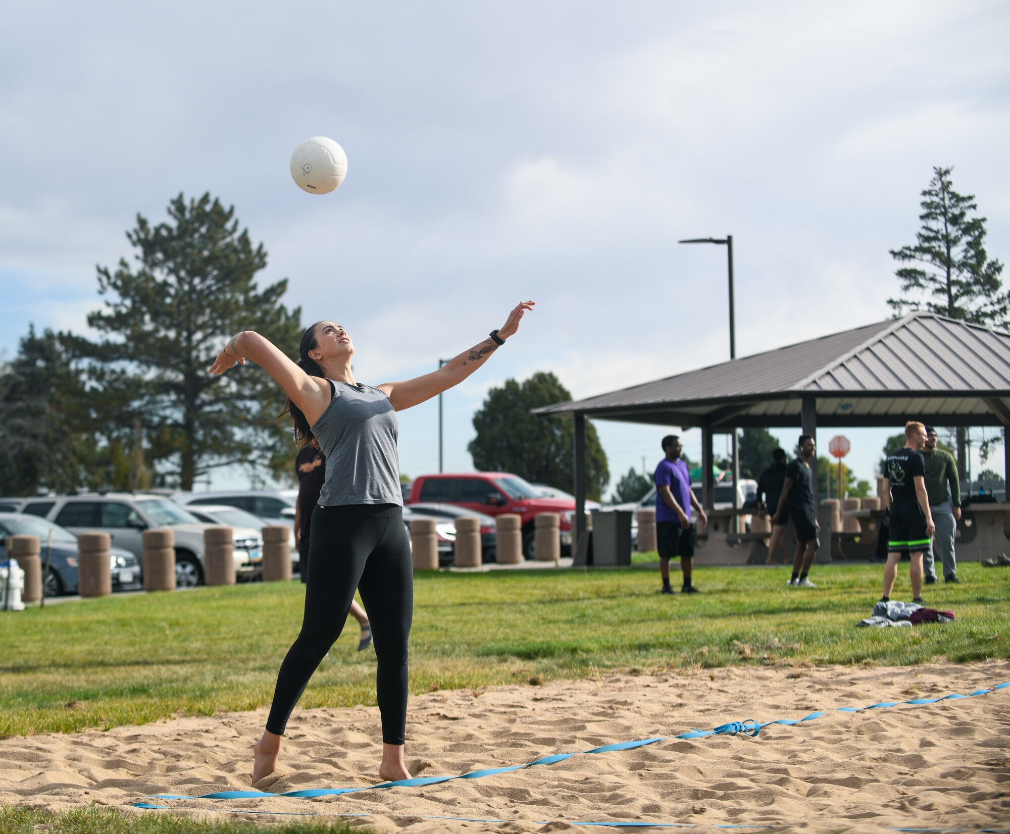 Airman 1st Class Yasmin Chraibi, a 460th Contracting Squadron contracting specialist, serves a volleyball at the Panther Dorm volleyball court on Buckley Air Force Base, Colo.