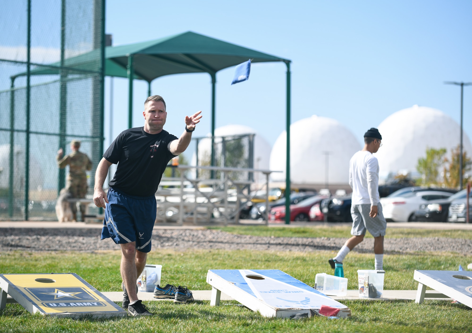Senior Master Sgt. Michael Grosebeck, the 460th Wing Staff Agency superintendent, throws a bean bag during a game of cornhole at the softball fields on Buckley Air Force Base, Colo.