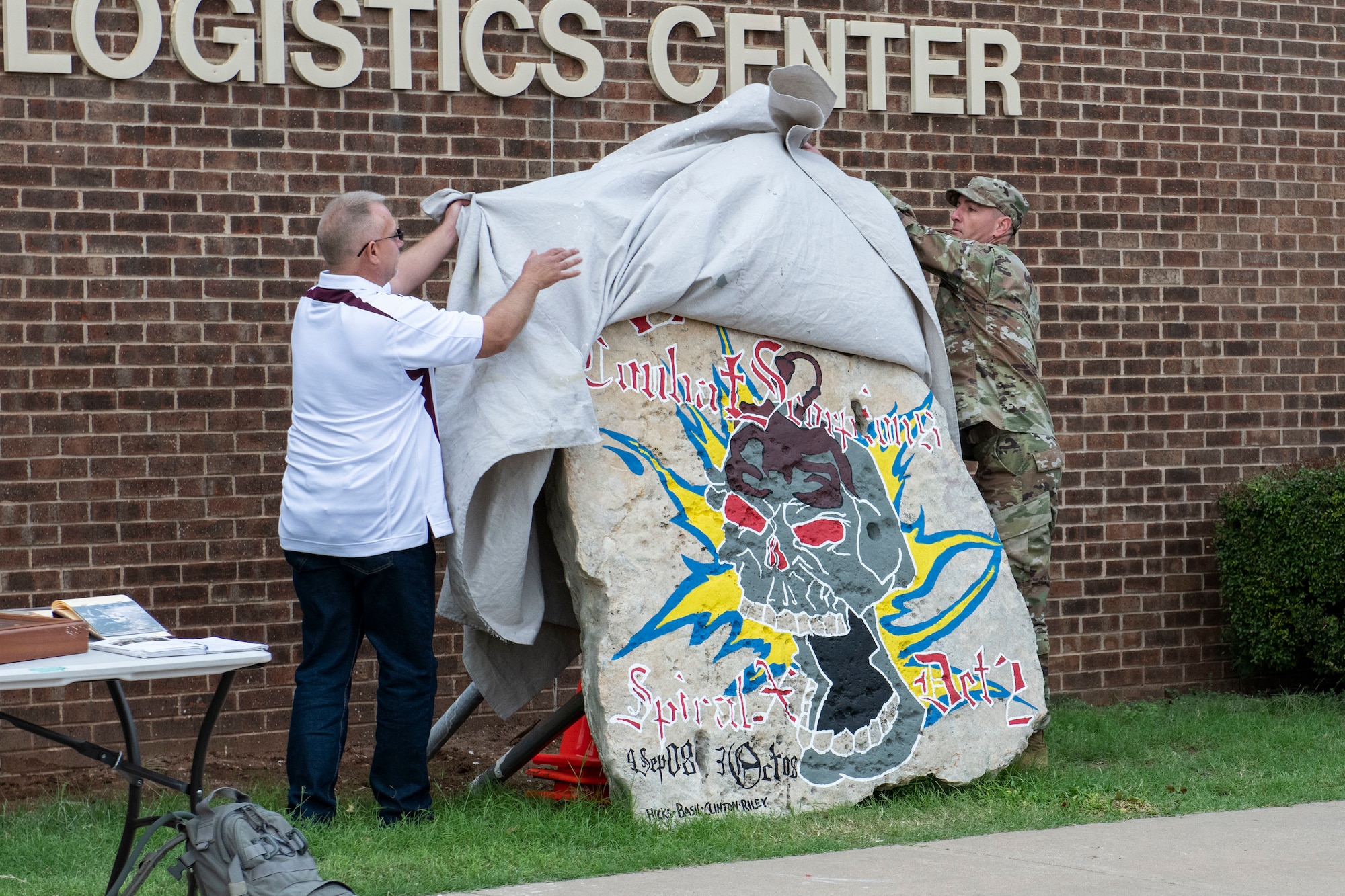 A Heritage Rock is displayed in front of the 97th Logistics Readiness Squadron.