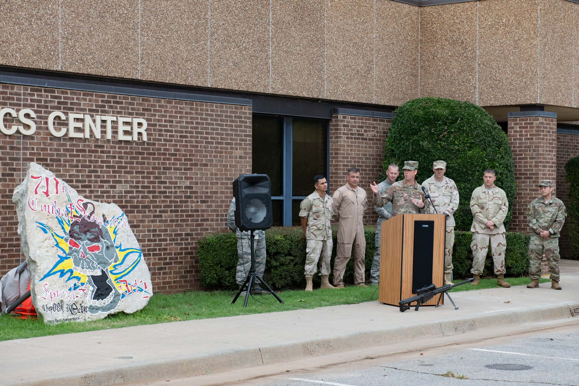A Heritage Rock is displayed in front of the 97th Logistics Readiness Squadron.