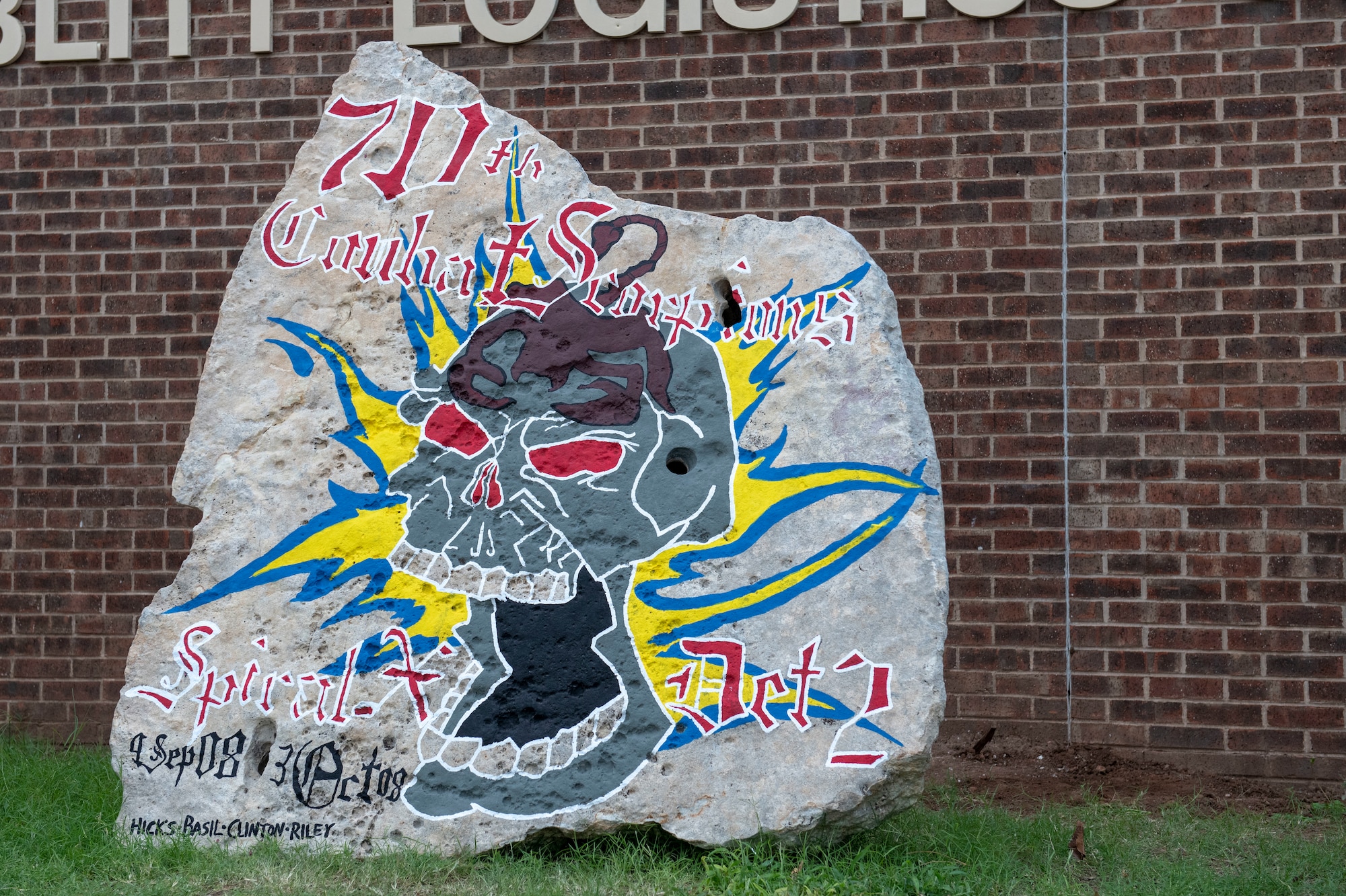A Heritage Rock is displayed in front of the 97th Logistics Readiness Squadron.