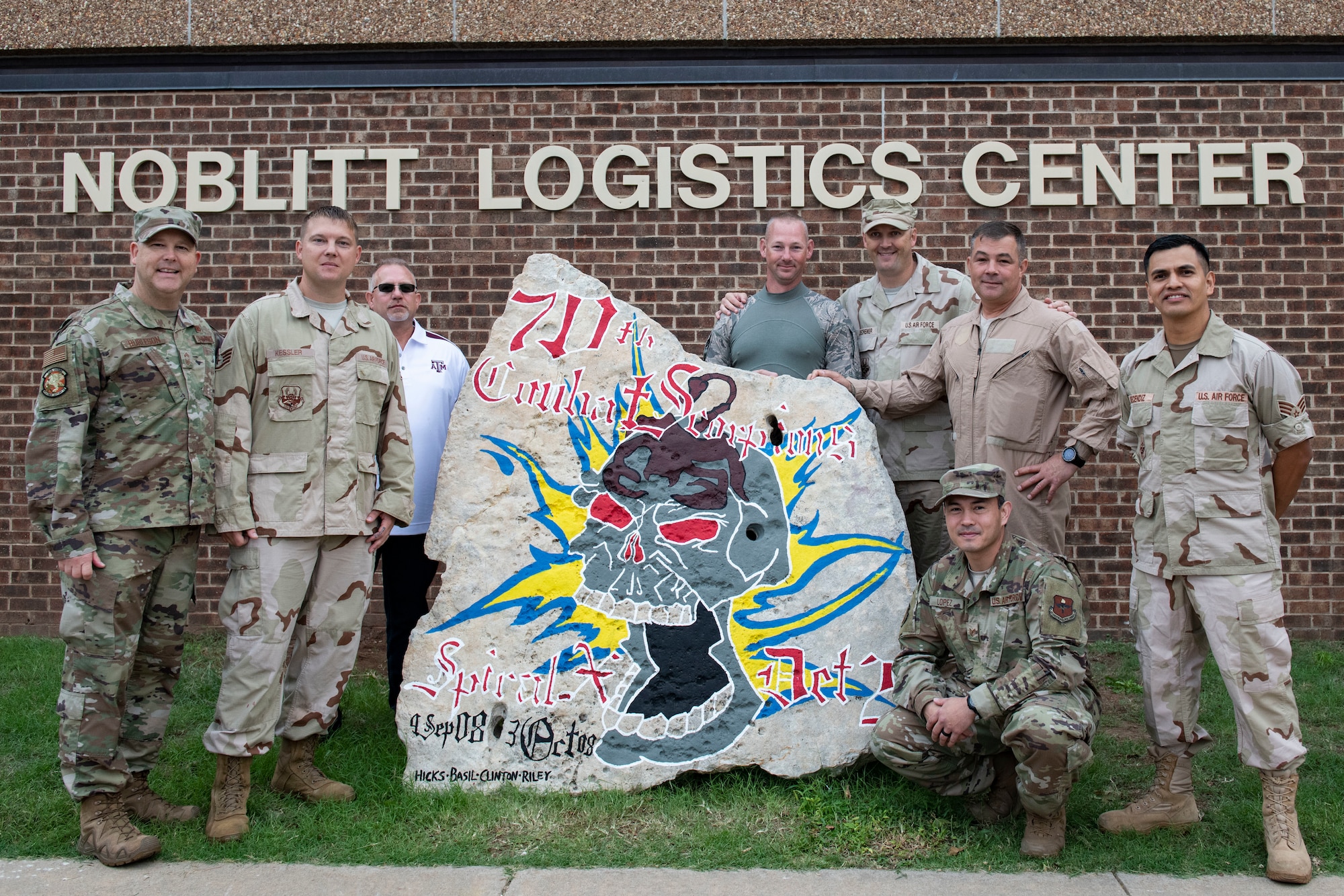 A Heritage Rock is displayed in front of the 97th Logistics Readiness Squadron.