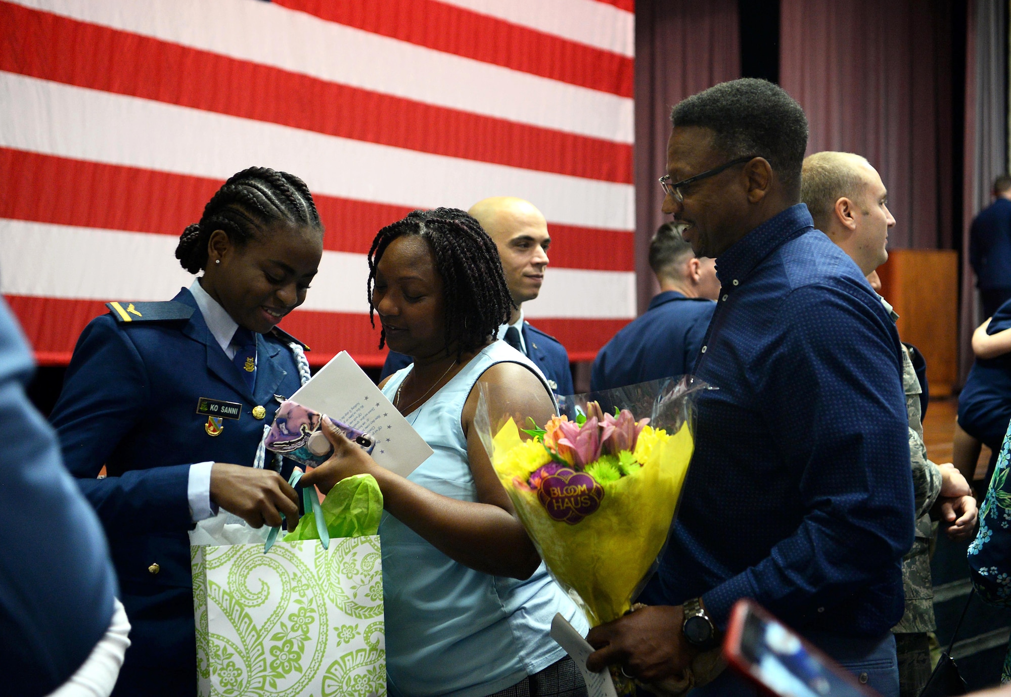 First Lt. Kafayat Sanni is congratulated by friends during a graduation ceremony Aug. 16, 2019, on Columbus Air Force Base, Miss. Sanni became the first female fighter pilot in the Nigerian air force upon graduating from the Aviation Leadership Program. (U.S. Air Force photo by Airman 1st Class Hannah Bean)