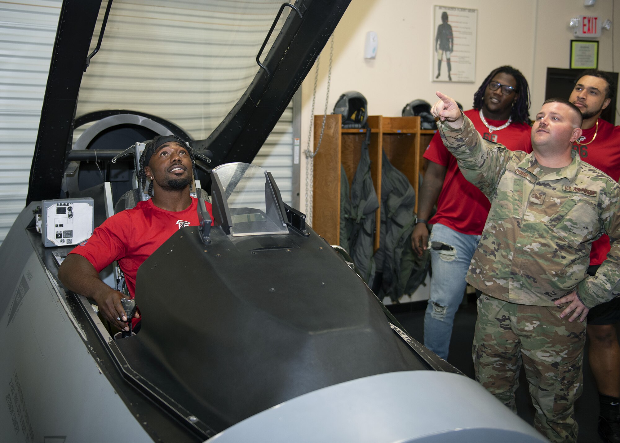 Tech. Sgt. Christopher Dorr, 56th Operations Support Squadron Aircrew Flight Equipment lead trainer, discusses the capabilities of the F-35A Lightning II to members of the Atlanta Falcons during their visit to the AFE facility, Oct. 8, 2019, at Luke Air Force Base, Ariz.