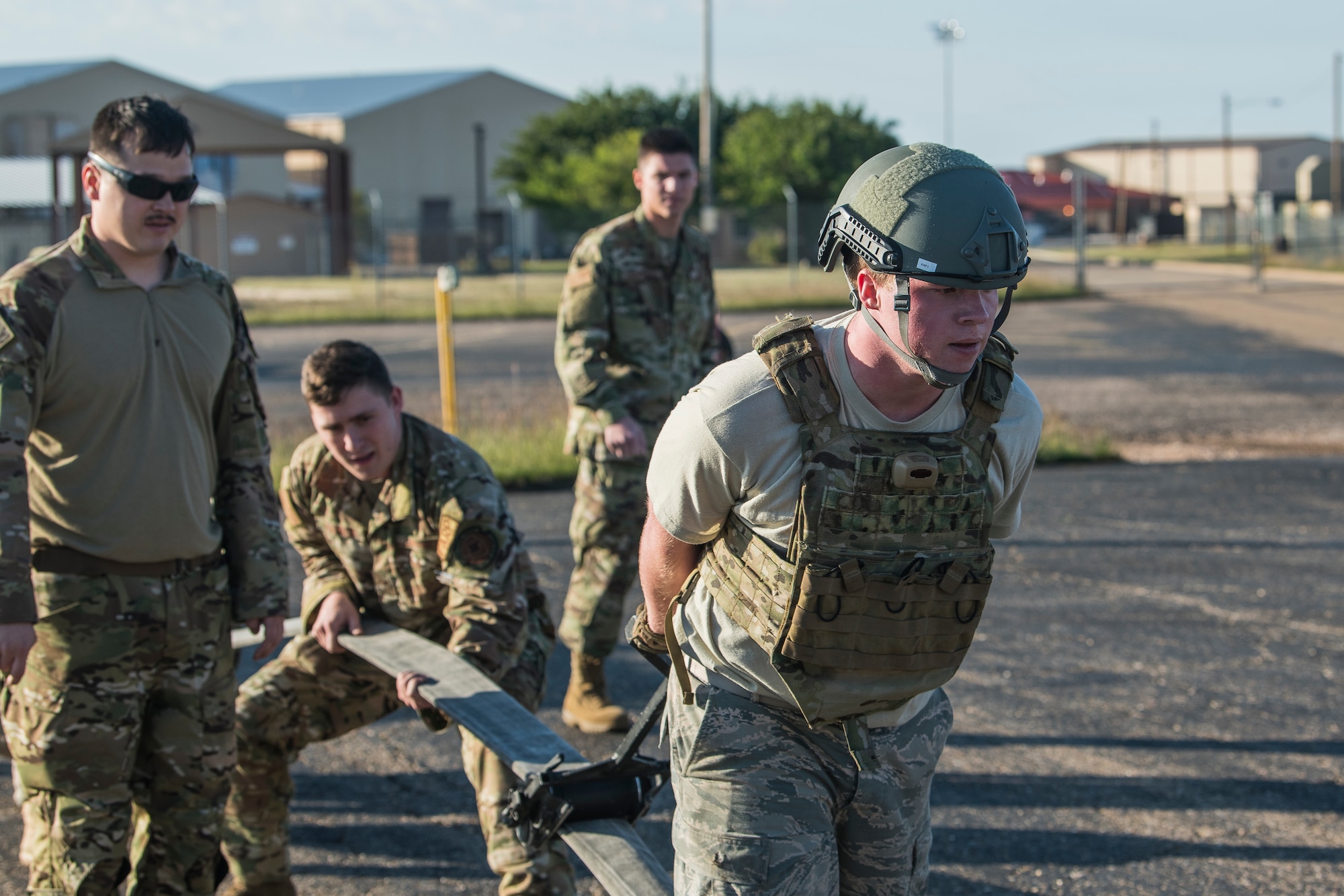 Airman 1st Class Kyle Fabrizius, 27th Special Operations Logistics Readiness Squadron fuels distribution technician, drags a roller across a fuel tube to empty it during the Forward Air Refueling Point tryouts at Cannon Air Force Base, N.M., October 9, 2019. During the tryouts, members do a physical test first and then are interviewed by the current FARP team. (U.S. Air Force photo by Senior Airman Vernon R. Walter III)