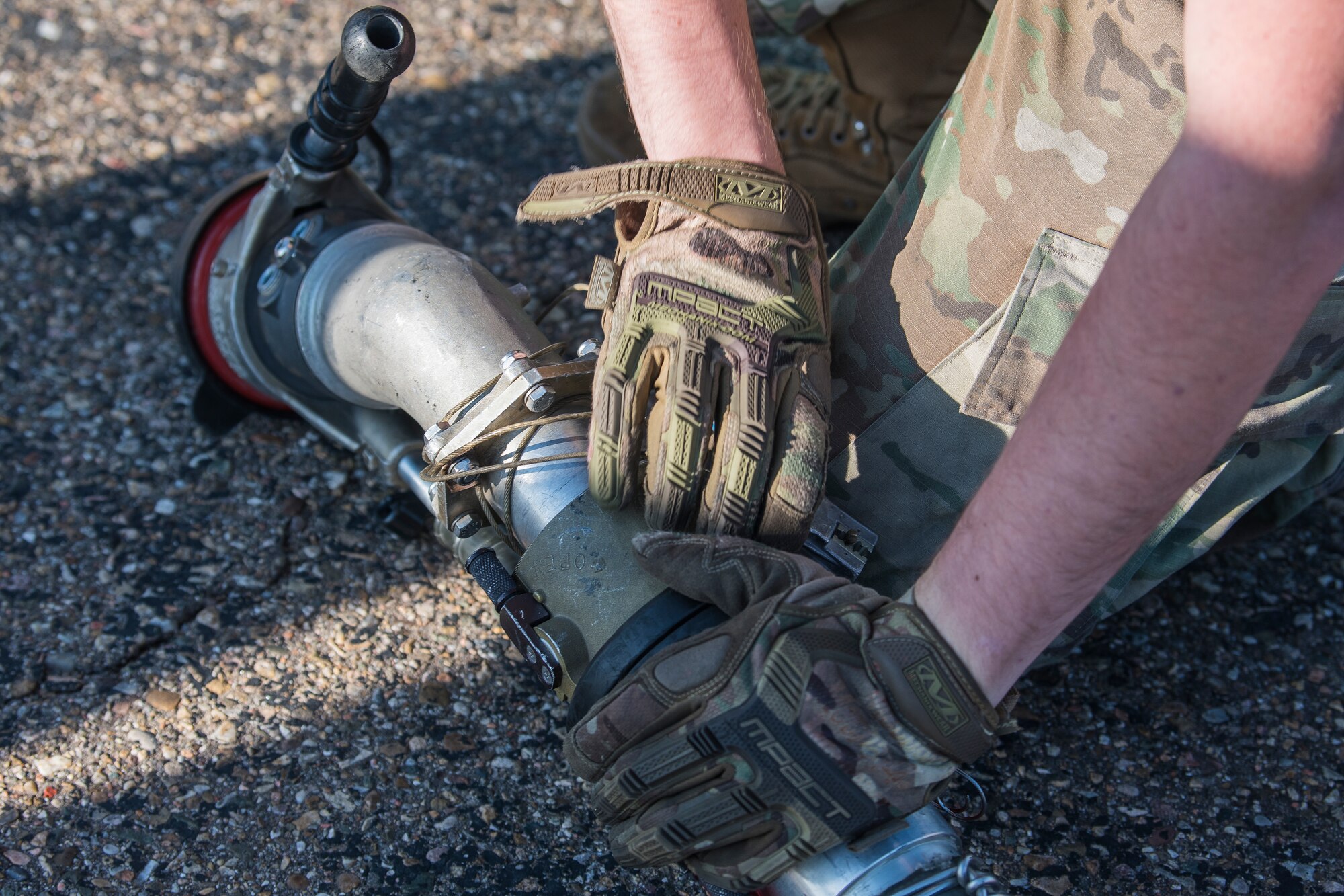 Airman 1st Class Caleb McDonald, 27th Special Operations Logistics Readiness Squadron fuels operator, unwinds a grounding cable from a fuel hose at the Forward Air Refueling Point tryouts at Cannon Air Force Base, N.M., October 9, 2019. The tryout has nine different tasks that have to be completed. (U.S. Air Force photo by Senior Airman Vernon R. Walter III)